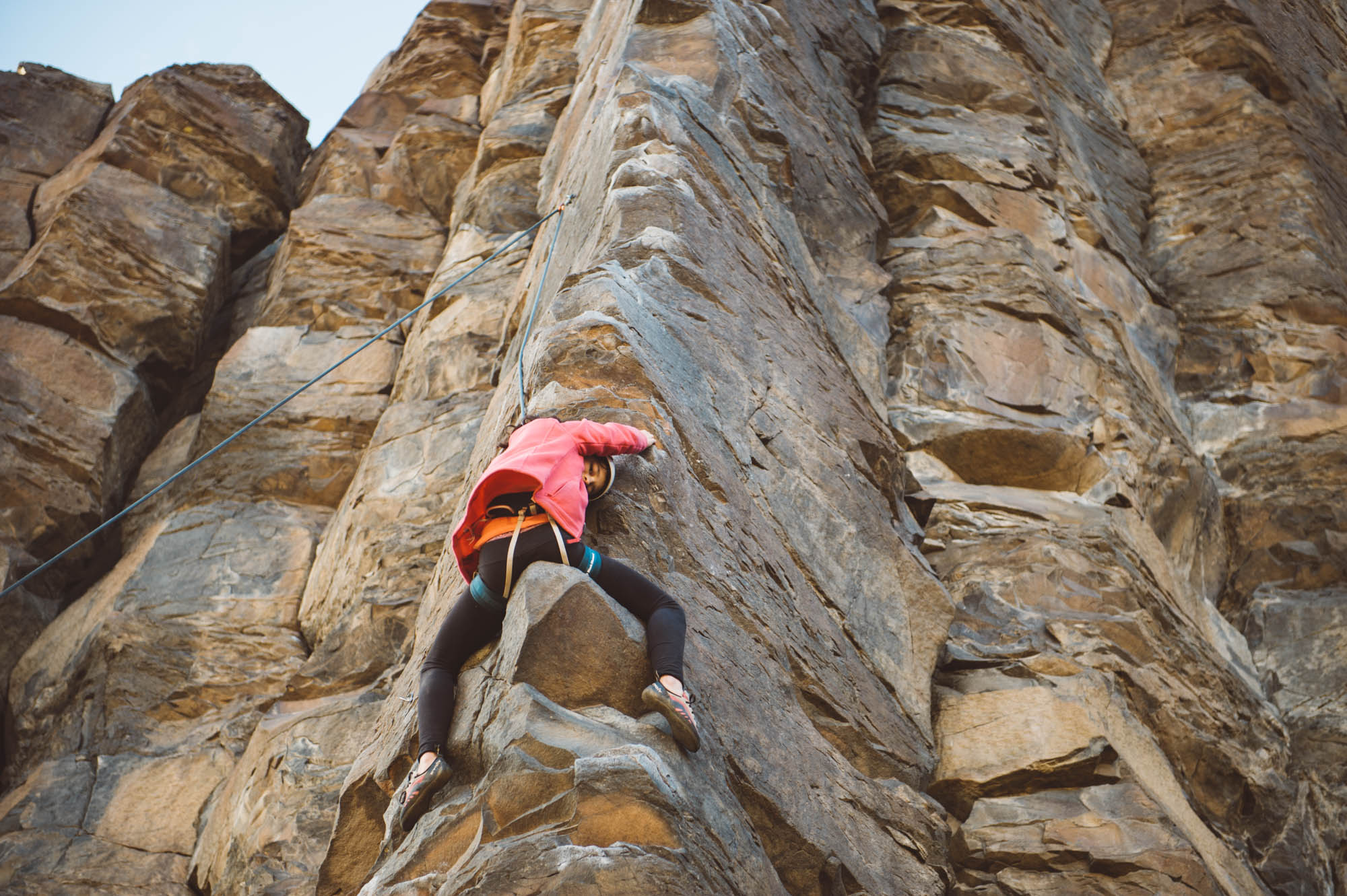 Mara sitting on the "saddle" of Ride 'em Cowboy (5.9+), one of the most popular route on this crag. There are always line ups here on the weekends!