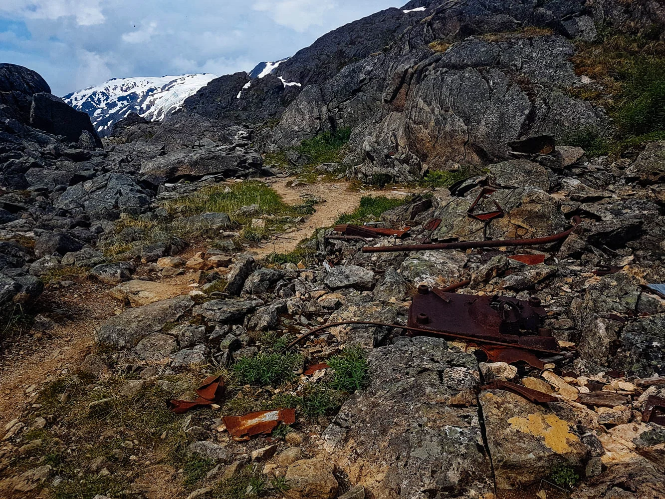 Within sight of the pass, and at the base of the "Golden Stairs" (the long difficult incline that leads to the pass), are The Scales. The Scales were a weight station where freight would be reweighed before the final trek to the pass. There are lots of artefacts there since a lot of people left things there and turned back or tried to lighten their load to make the final push...