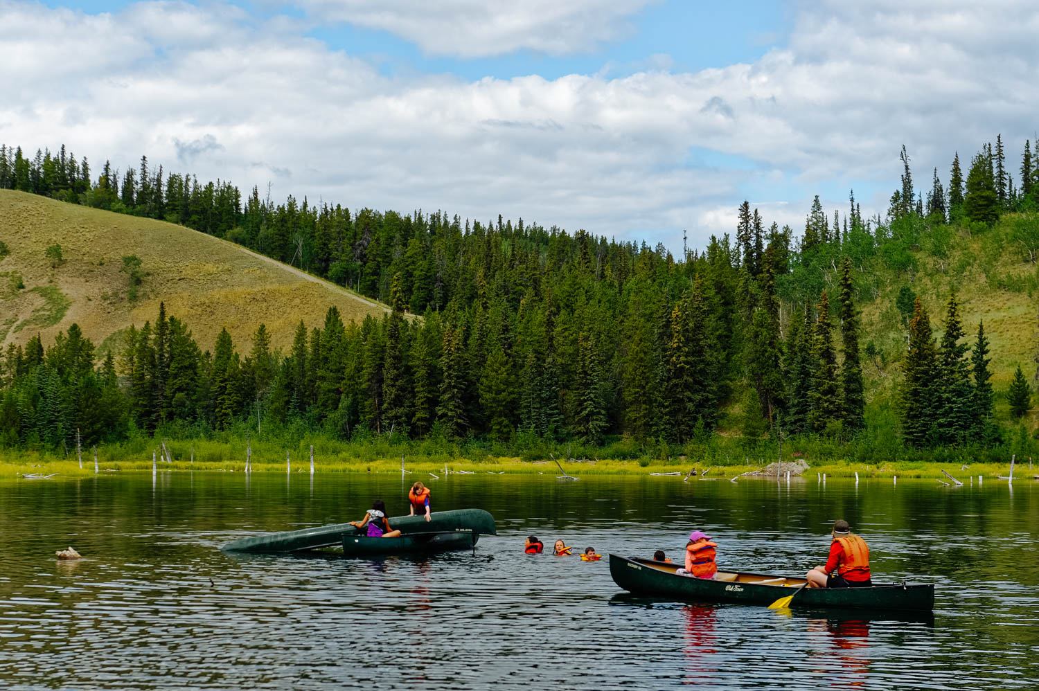 Then, proceed with rescue mission by sliding the tipped canoe over the rescuers canoe.