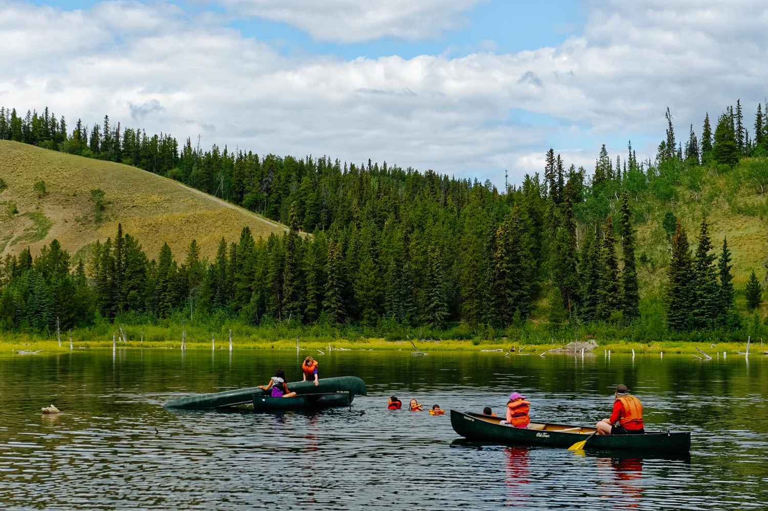Then, proceed with rescue mission by sliding the tipped canoe over the rescuers canoe.