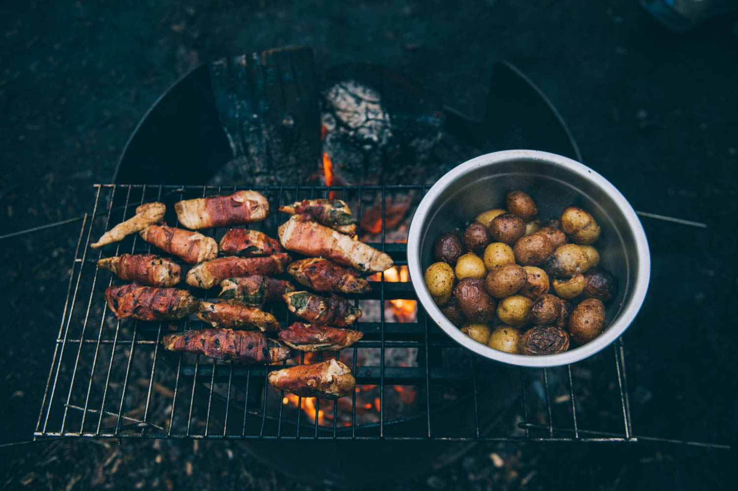 Prosciutto and sage leaves wrapped chicken and potatoes over the fire.