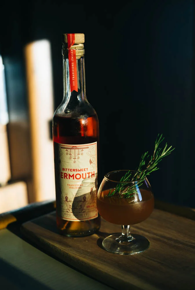 My Manhattan 2 oz rye whiskey 3/4 oz @oddsocietyspirits Italian bittersweet Vermouth 1/2 oz rosemary honey syrup 3 dashes orange sage bitters Stir with ice and strain. Garnish with a rosemary sprig.