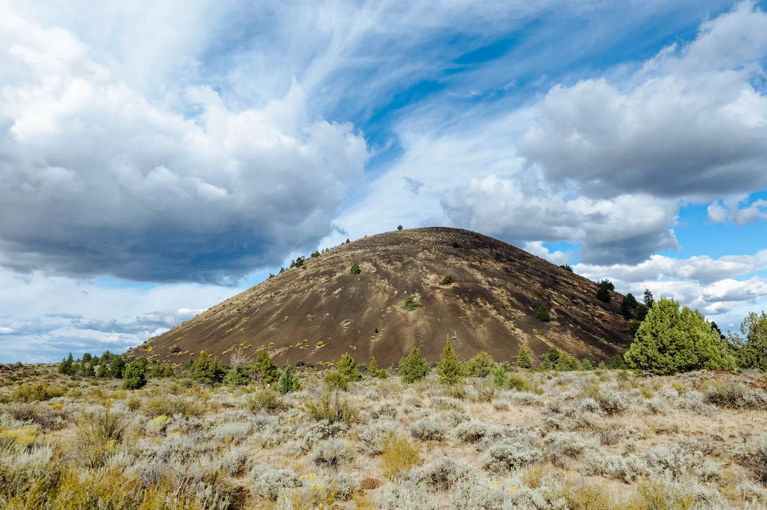 One of the many cinder cones in the national monument. Cinder Cones are the simplest type of volcanoes. They are built of particles and blobs of congealed lava ejected from a single vent. Cinder cones typically erupt only once.