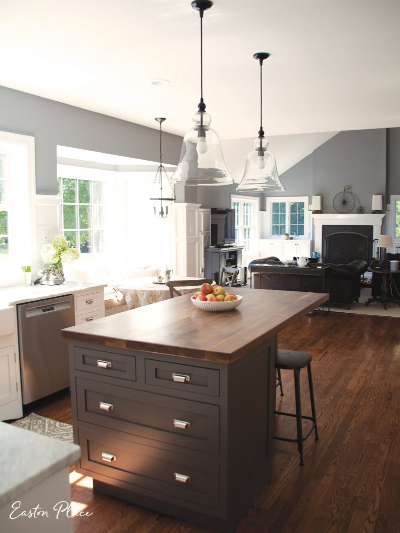 The island now has more storage space, and the custom walnut top, from Lorimer Studio , adds warmth to the area. (Duluth Pulls by Restoration Hardware)