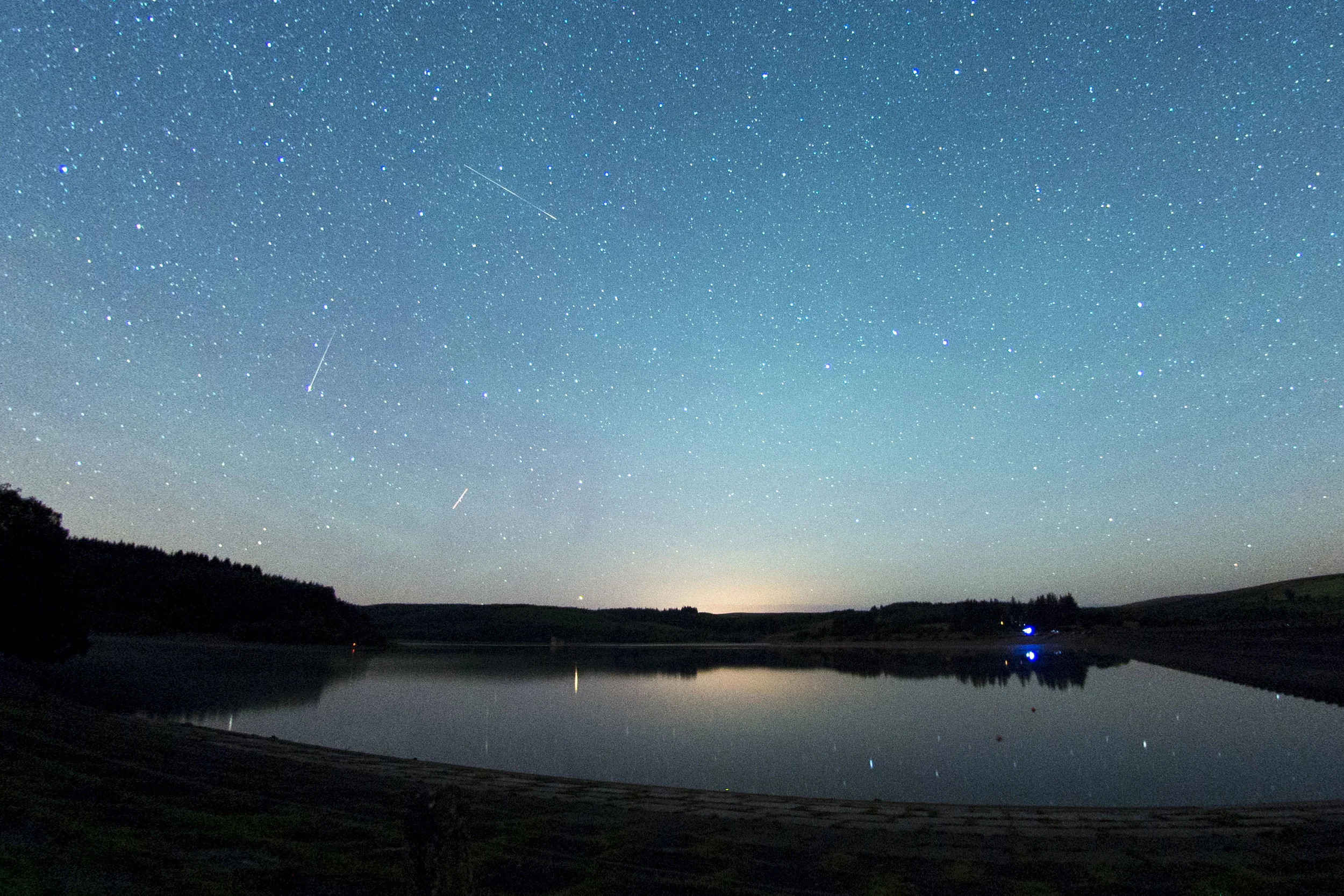 Perseid Meteor Shower 2015 at Usk reservoir, Brecon. The Perseids are pieces of Comet Swift-Tuttle - each August, the Earth passes through a cloud of the comet's debris.