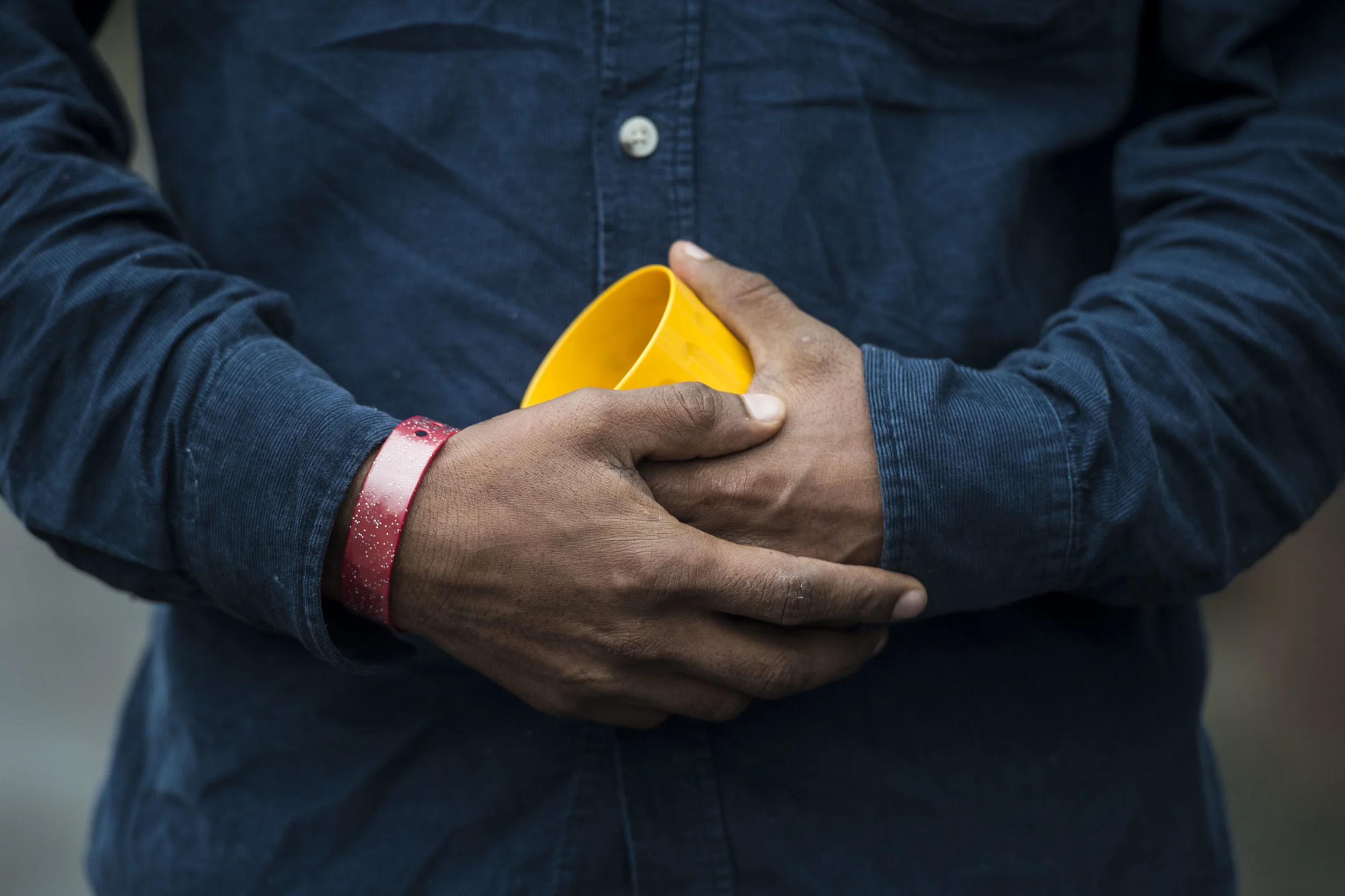 Asylum seekers staying at Lynx House on Newport Road in Cardiff, South Wales, have been given brightly coloured wrist bands to wear in order to claim food. (Photo by Matthew Horwood)