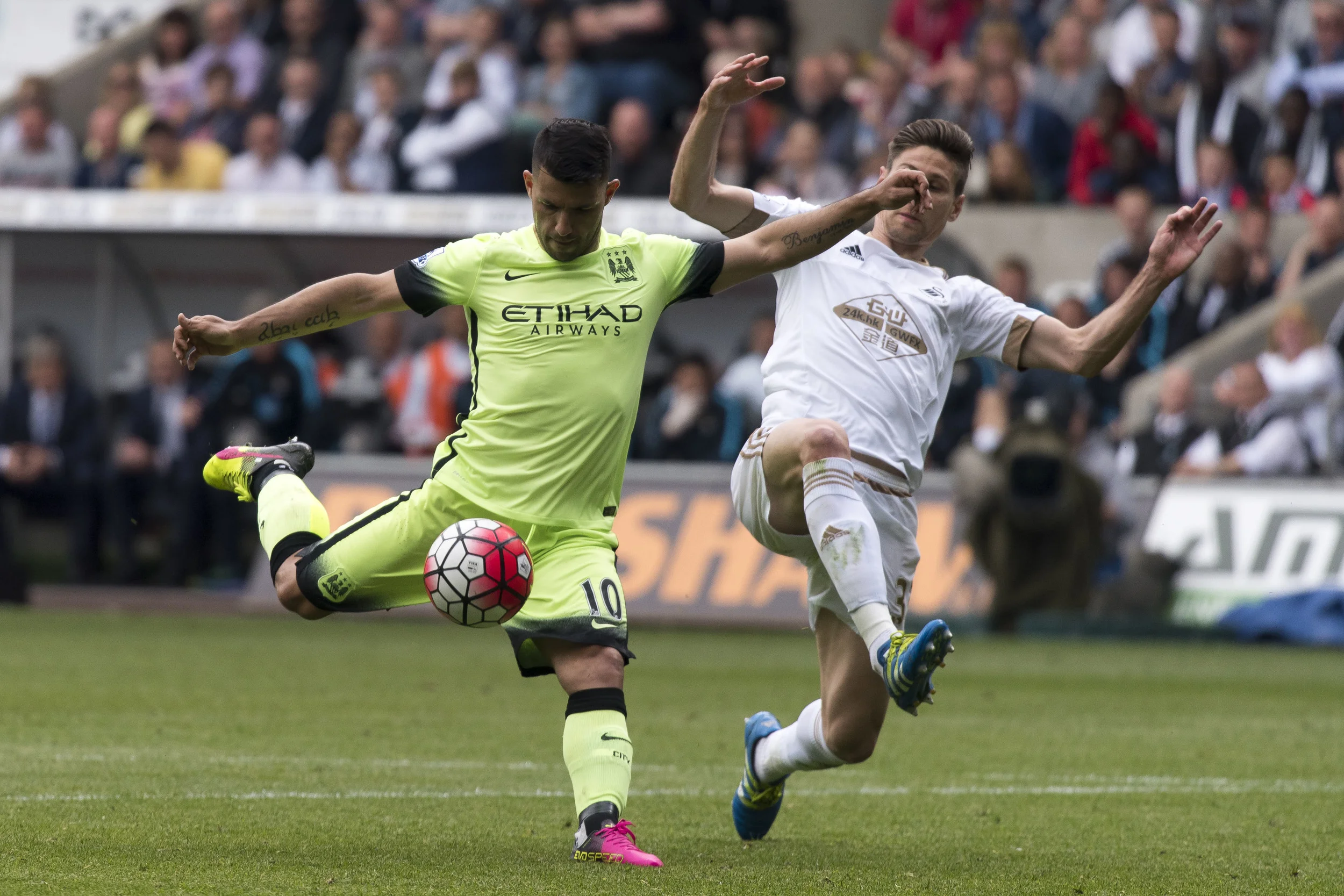 Swansea City v Manchester City Barclays Premier League match at the Liberty Stadium, Swansea. Picture shows Sergio Aguero of Manchester City having a shot on goal whileFederico Fernandez of Swansea City attempts a tackle. PIC Matthew Horwood © WALES NEWS SERVICE