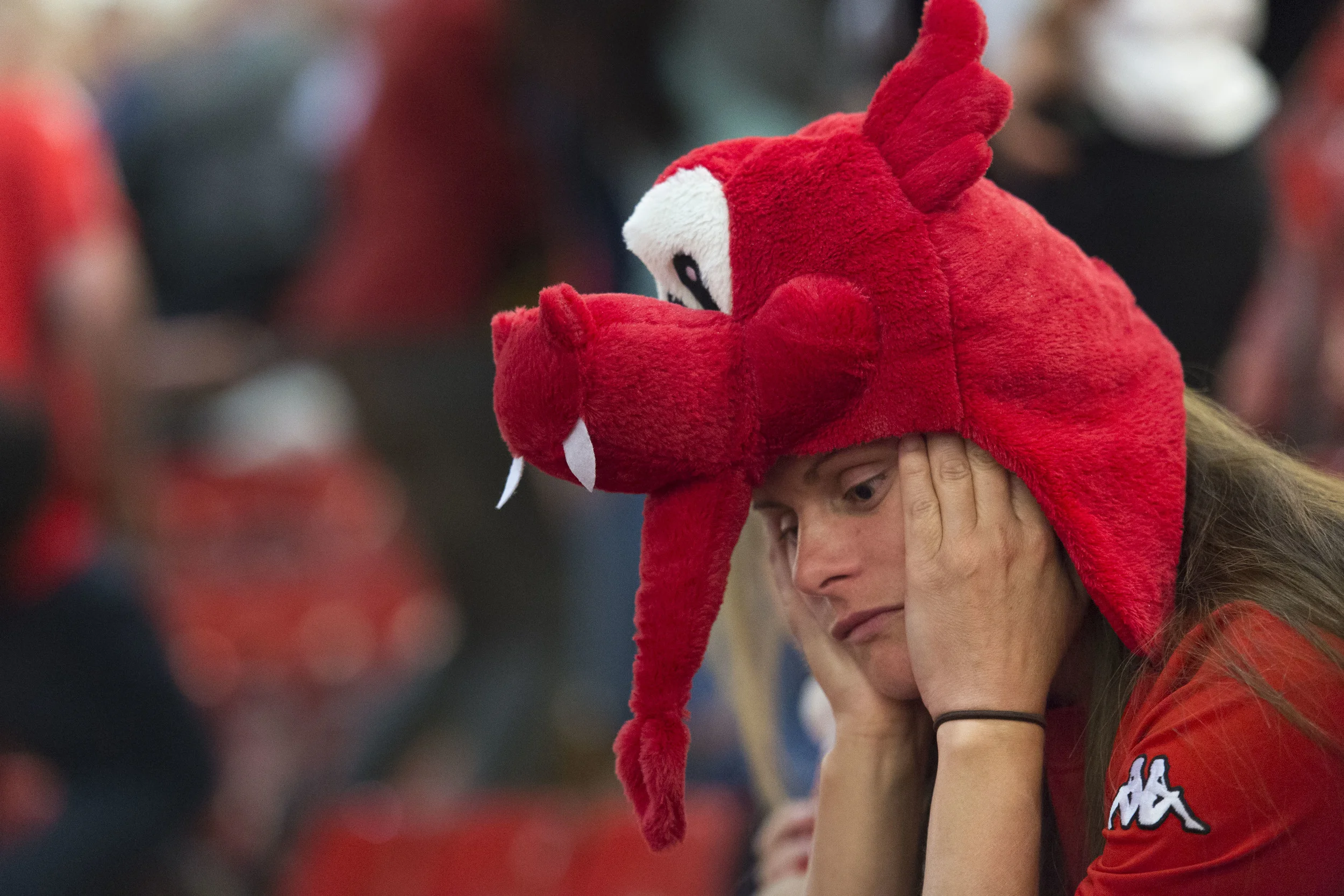 CARDIFF, WALES - JULY 06: A dejected Welsh football fan looks on while watching the Wales v Portugal Euro 2016 semi-final match on a big screen in the Principality Stadium on July 6, 2016 in Cardiff, Wales. Portugal beat Wales 2-0 at Stade de Lyon in France, knocking Wales out of the competition. (Photo by Matthew Horwood) 