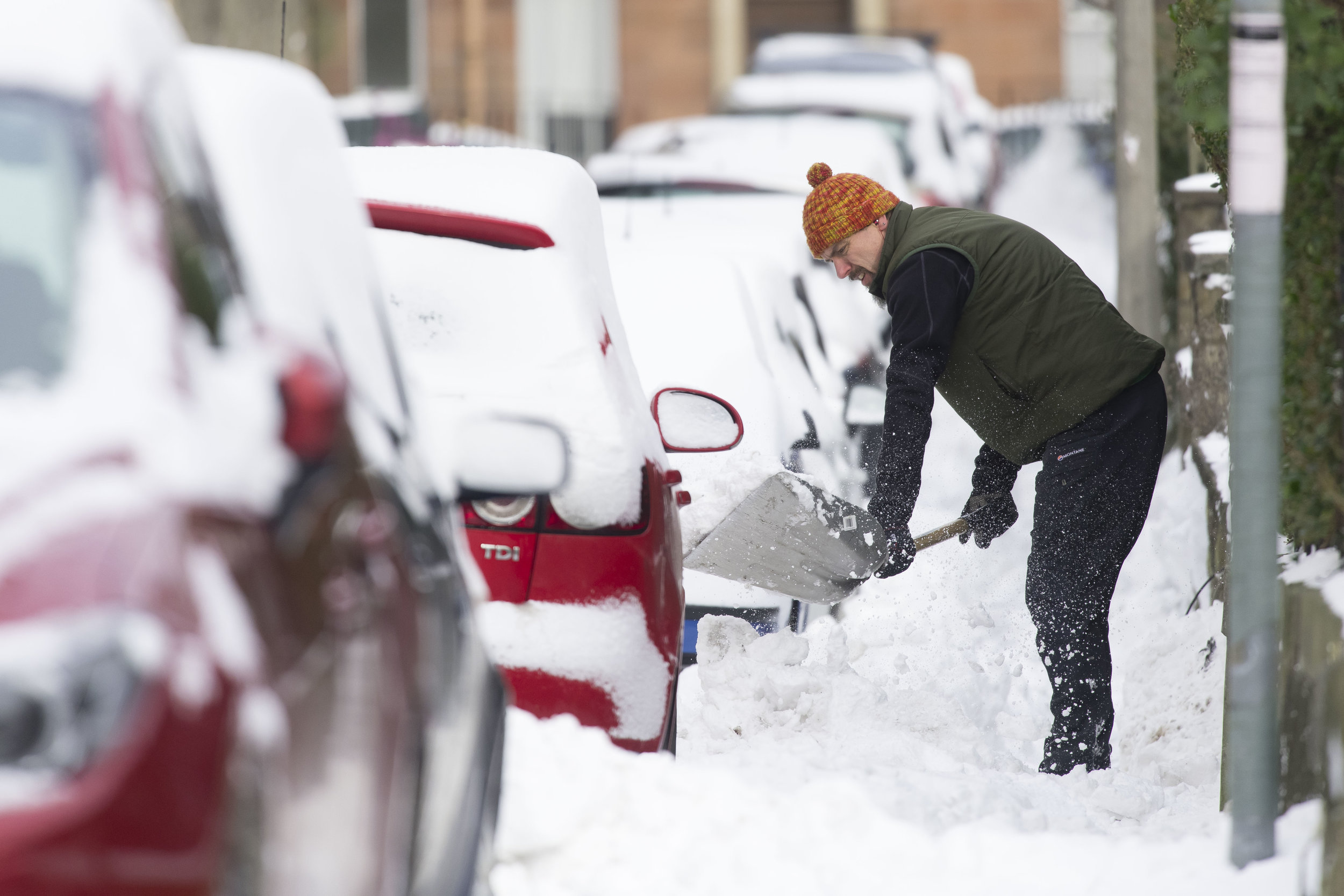  EDINBURGH, SCOTLAND - MARCH 1: A man clears snow from the pavement on March 1, 2018 in the Abbeyhill area of Edinburgh, United Kingdom. People have been warned not to make unnecessary journeys as the Met office issues a red weather be aware warning 