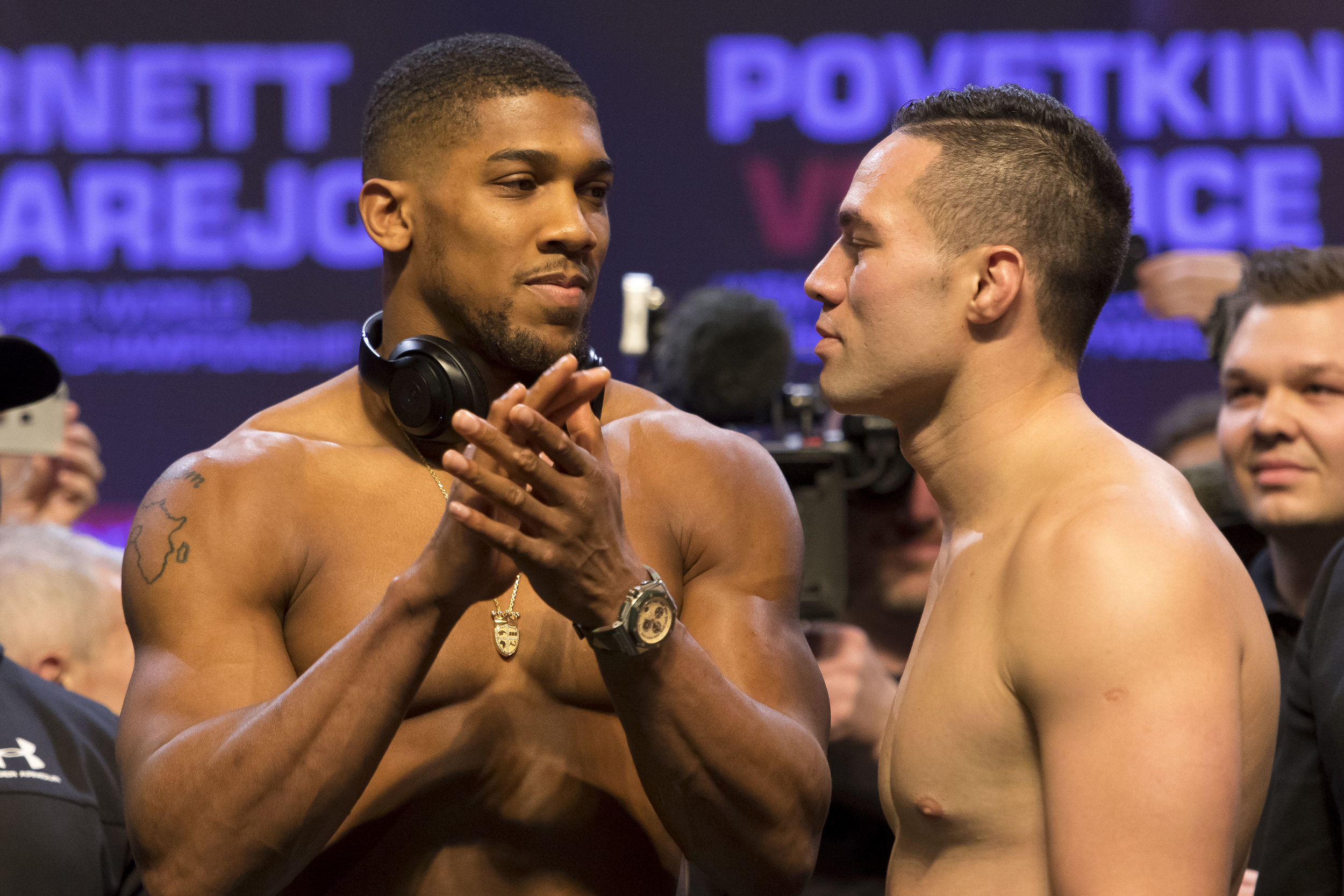  CARDIFF, WALES - MARCH 30: Anthony Joshua (L) and Joseph Parker (R) at the weigh-in at the Motorpoint Arena on March 30, 2018 in Cardiff, Wales. Anthony Joshua will fight Joseph Parker in a heavyweight unification match at the Principality Stadium i