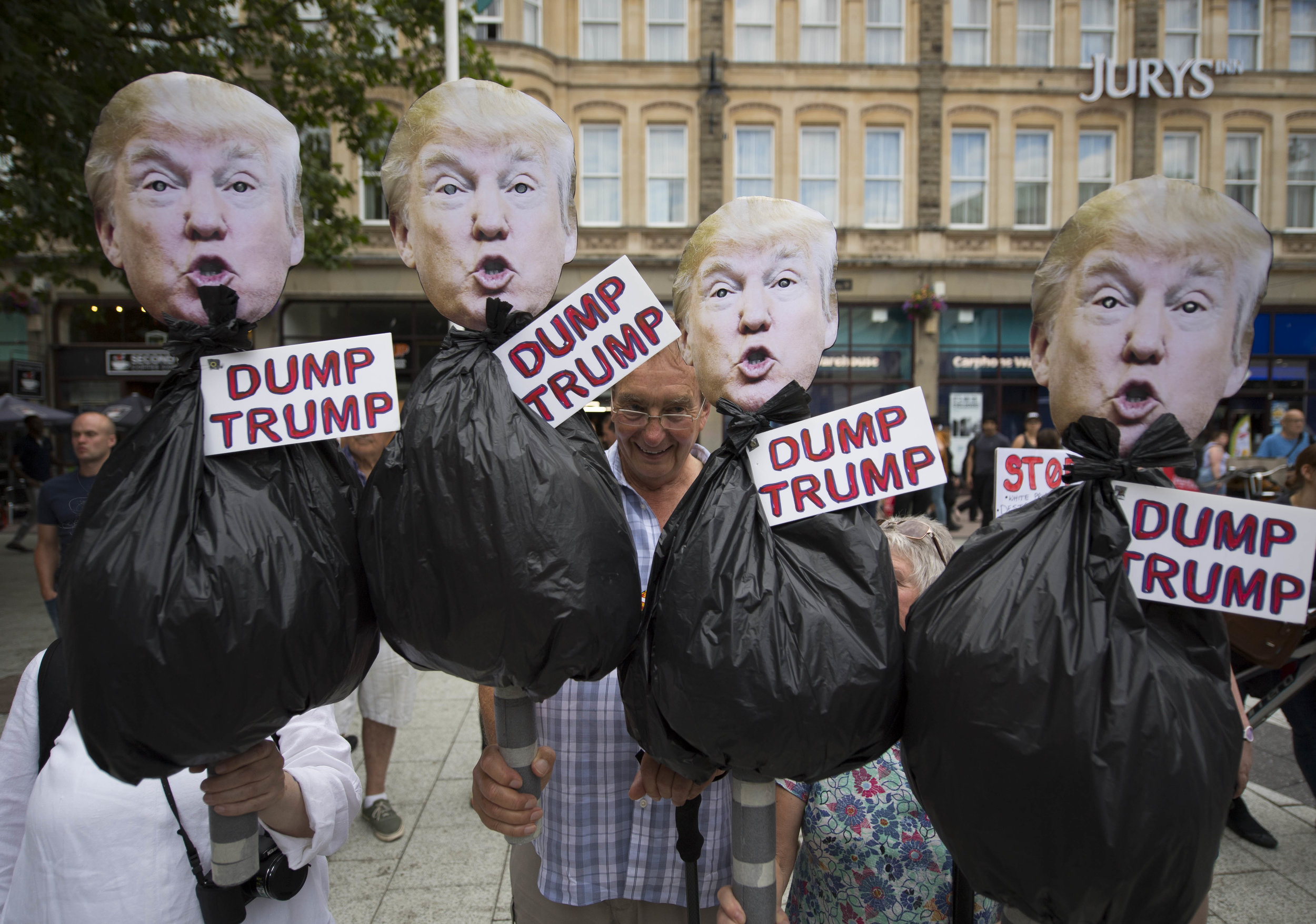  CARDIFF, UNITED KINGDOM - JULY 12: Protestors hold anti Donald Trump signs during a protest on Queen Street against a visit by the President of the United States Donald Trump on July 12, 2018 in Cardiff, United Kingdom. The President of the United S