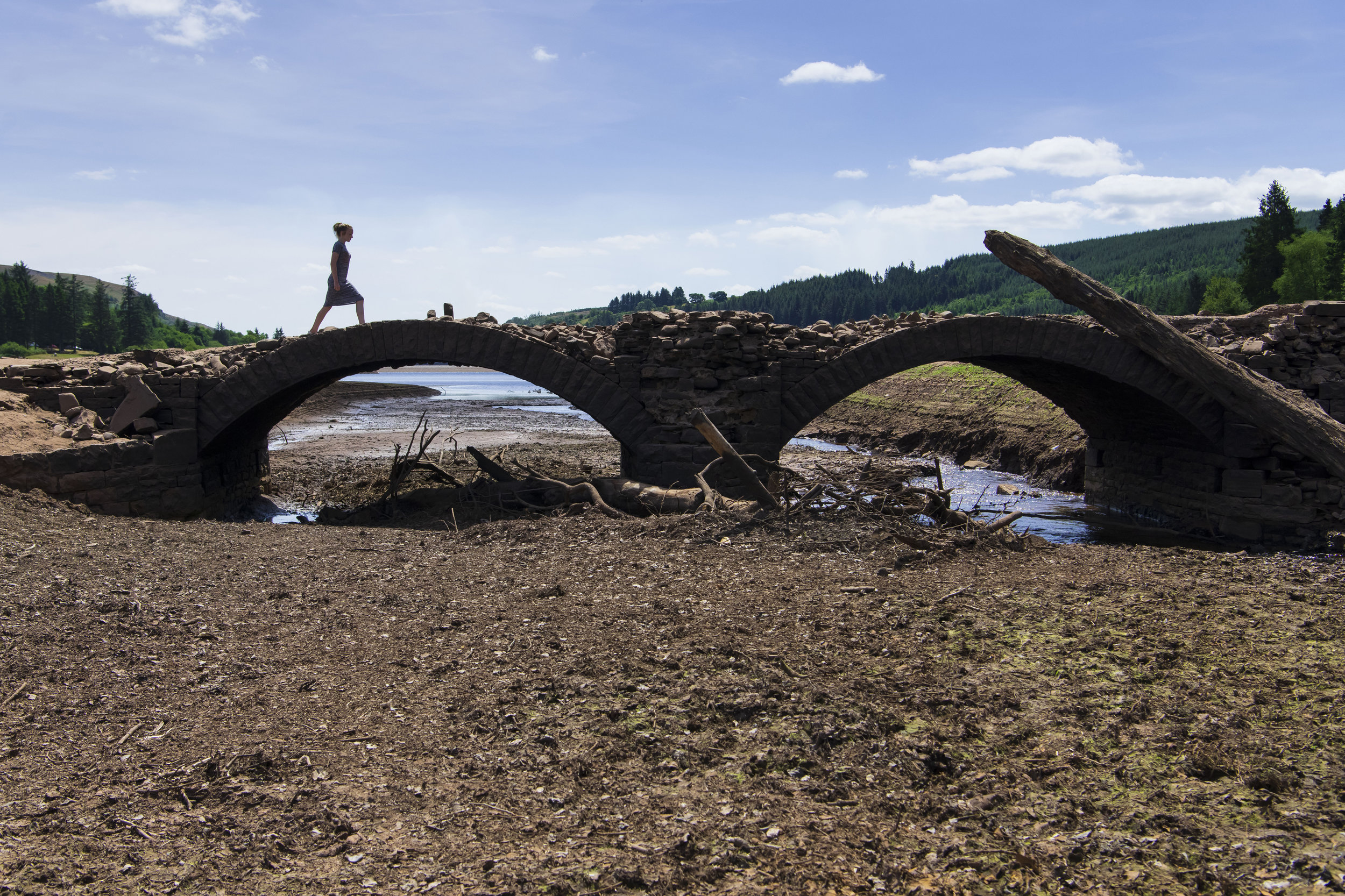  MERTHYR TYDFIL, WALES - JULY 25: A girl crosses a bridge at the Llwyn-on Reservoir, owned by Welsh Water, in the Taf Fawr valley on July 25, 2018 in Merthyr Tydfil, Wales. The lack of rainfall over the last few weeks combined with record breaking te