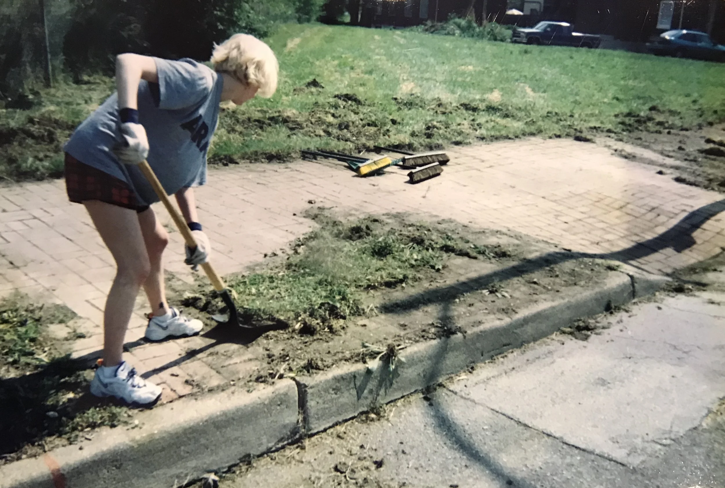 A volunteer cleans Soulard’s brick sidewalks