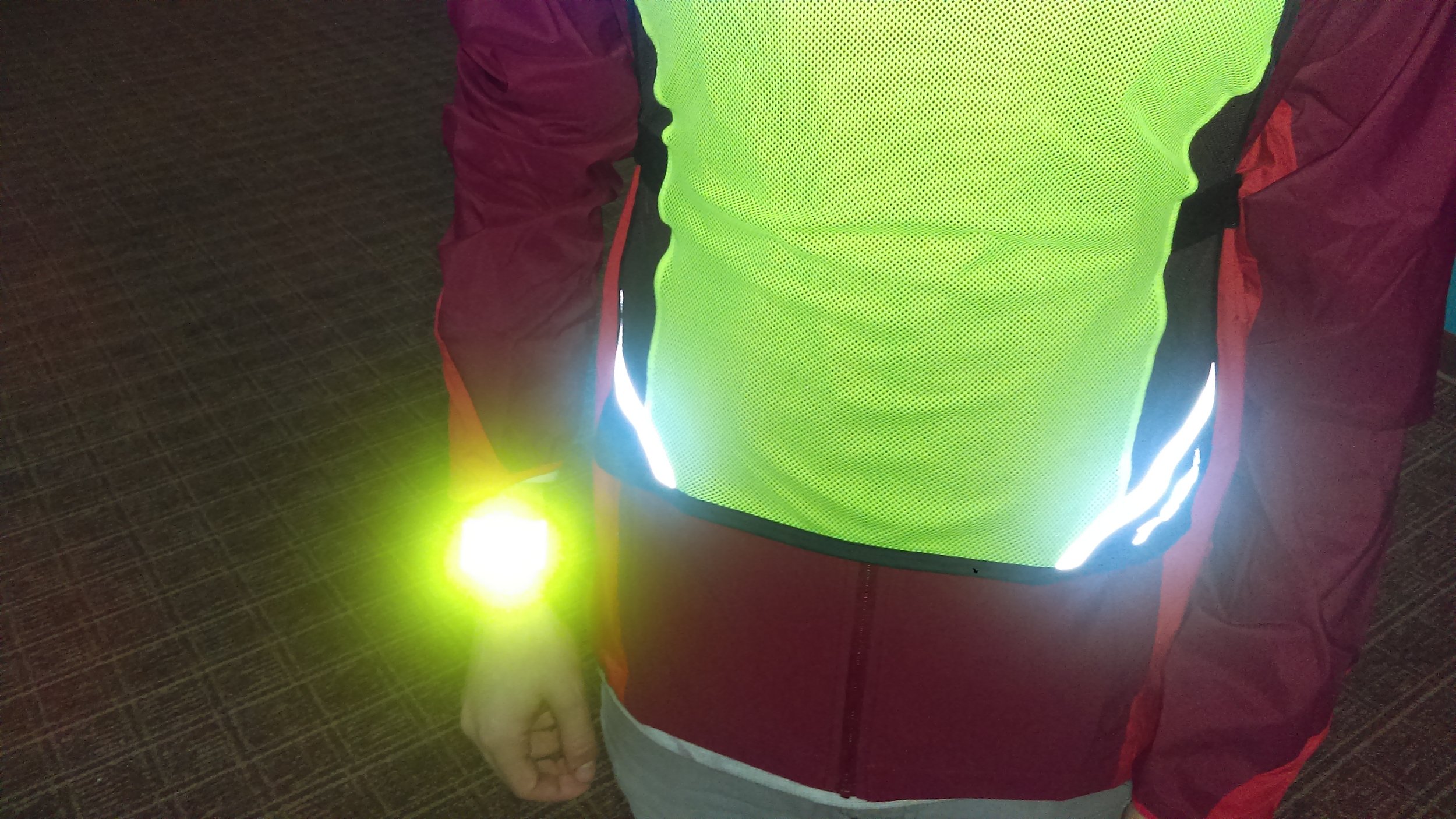 Here, Jason models our reflective slap-on bracelet which is both easy to strap onto a wrist (or ankle) and also very visible! Running with an arm bracelet provides short bursts of light that can break up a driver’s vision and make it easier to be seen. The same thinking goes into blinking lights.