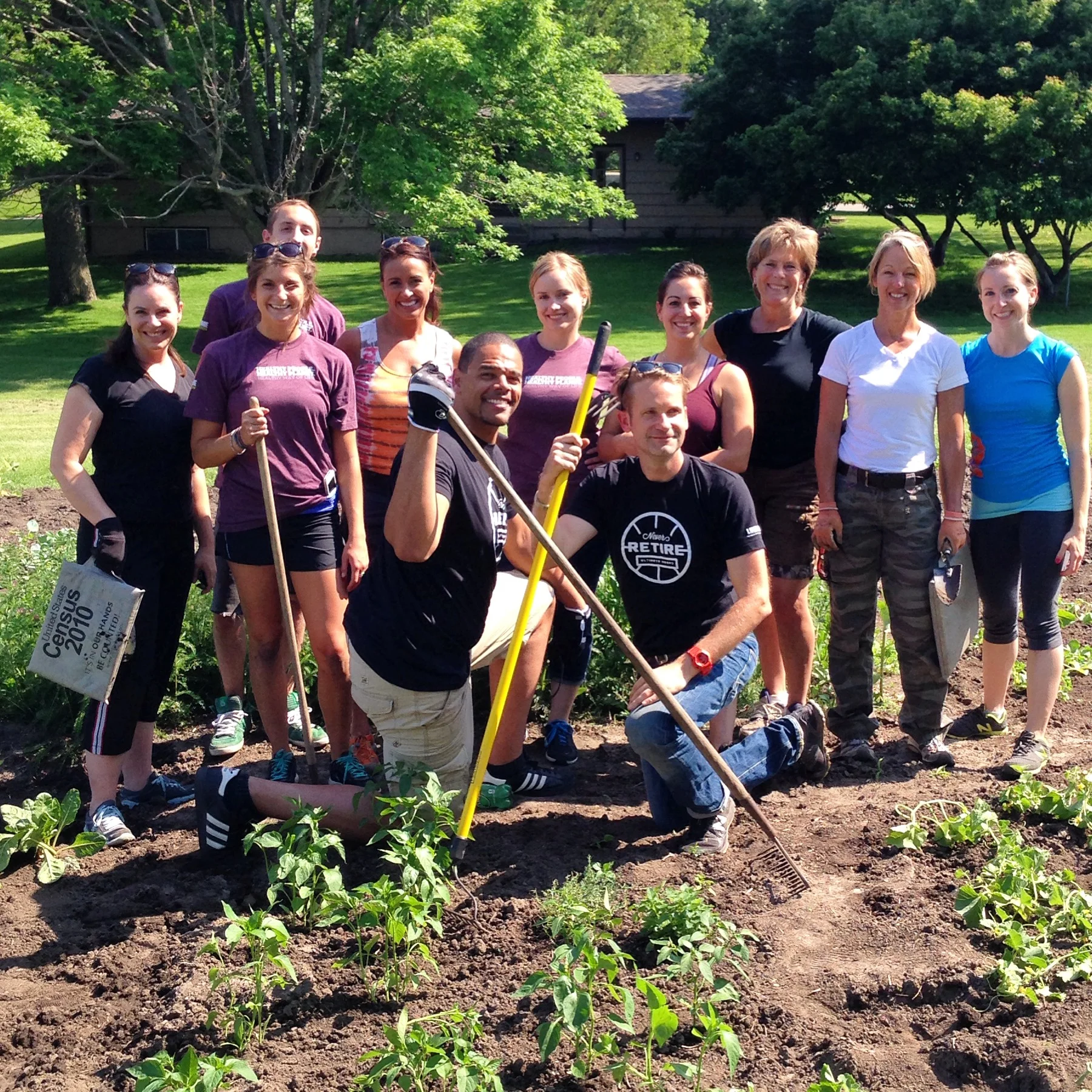 Ultimate Hoops' John Thomas (kneeling left) and Alan Arlt (kneeling right) volunteered with others from Life Time Fitness to help Grow.Eat.Share.
