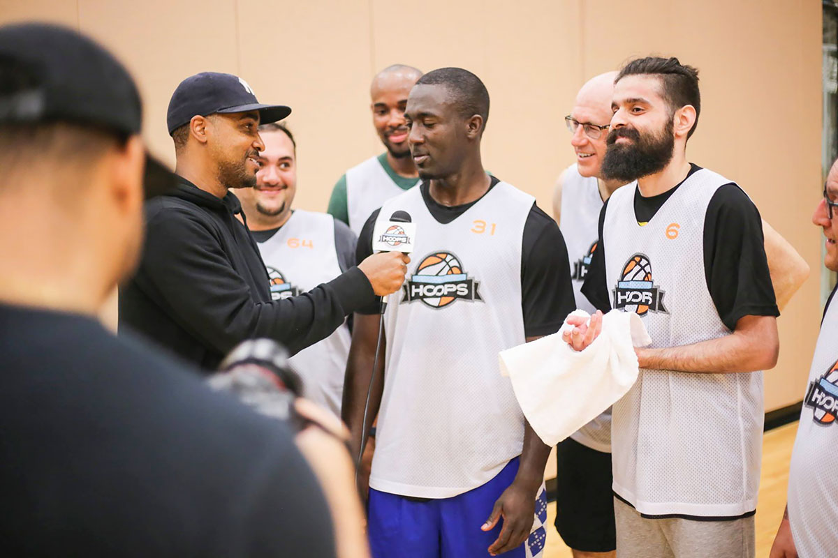 Daniel (left) interviewing league players in Ultimate Hoops Toronto