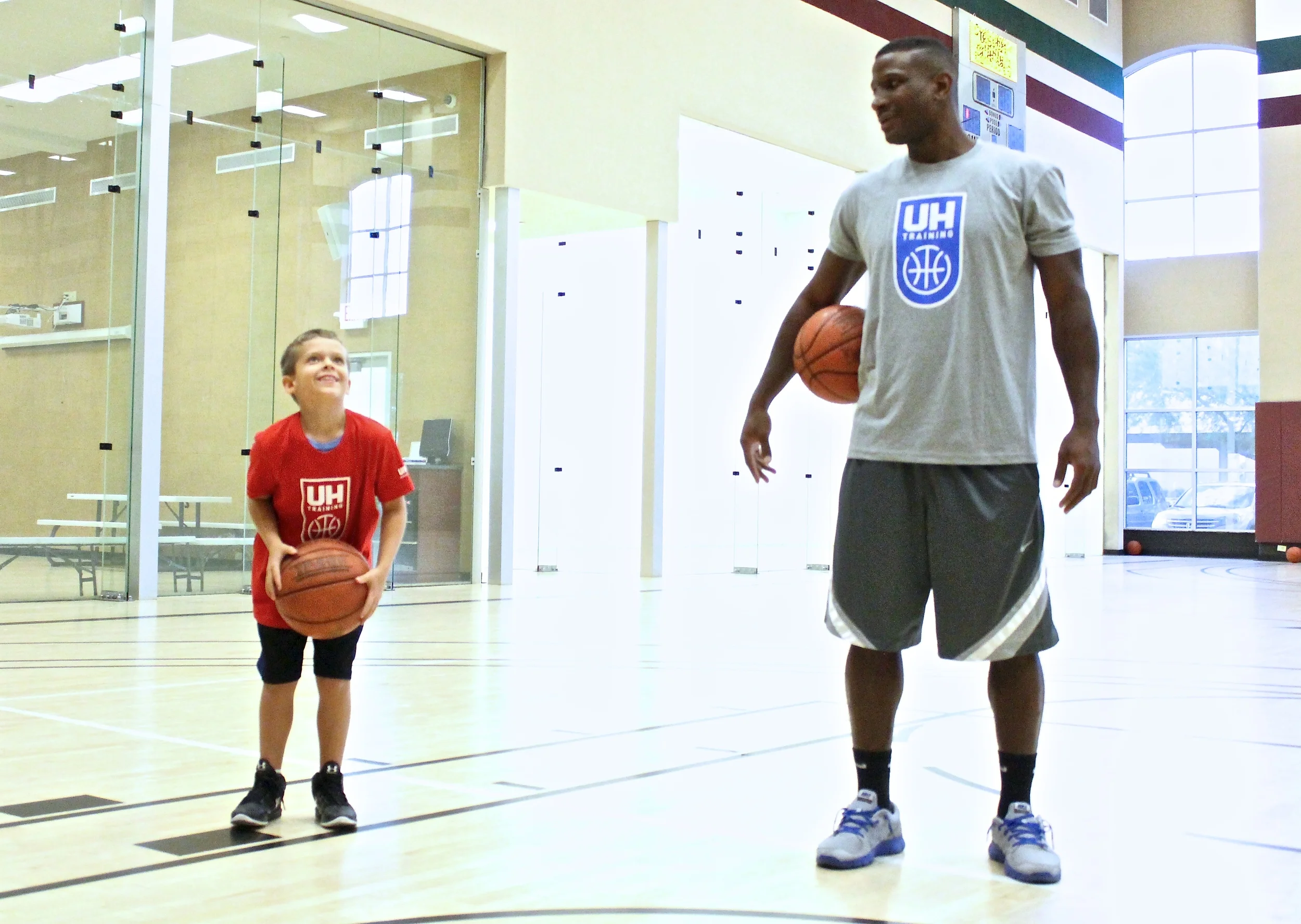 John McFall Jr. eyes up the basket under the watchful eye of his Ultimate Hoops basketball trainer, Tyrone Jones. McFall was diagnosed with Leukemia in 2015. (photo by Donald Dangmuk)