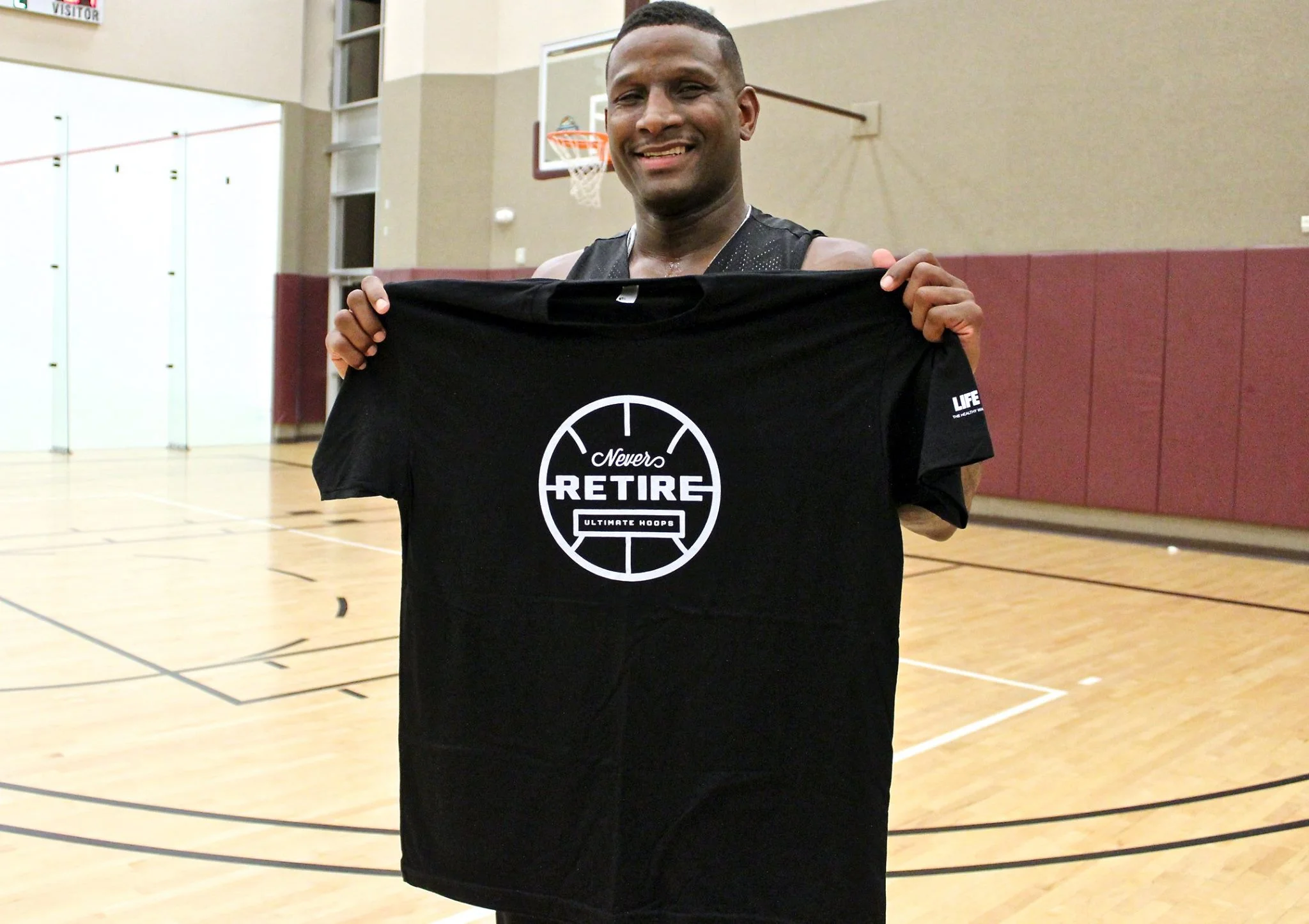 Tyrone "TJ" Jones holding up his MVP T-Shirt. (photo by Donald Dangmuk)