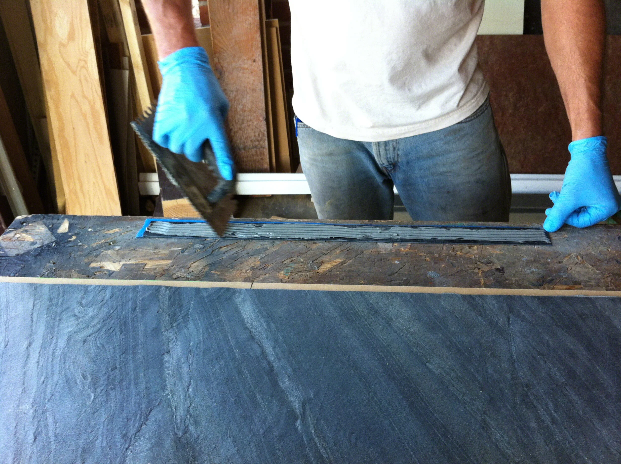 txtr-lite-flexible-stone-veneer-bathroom-vanity-wwside strip adhesive application with 316 v notch trowell.jpg