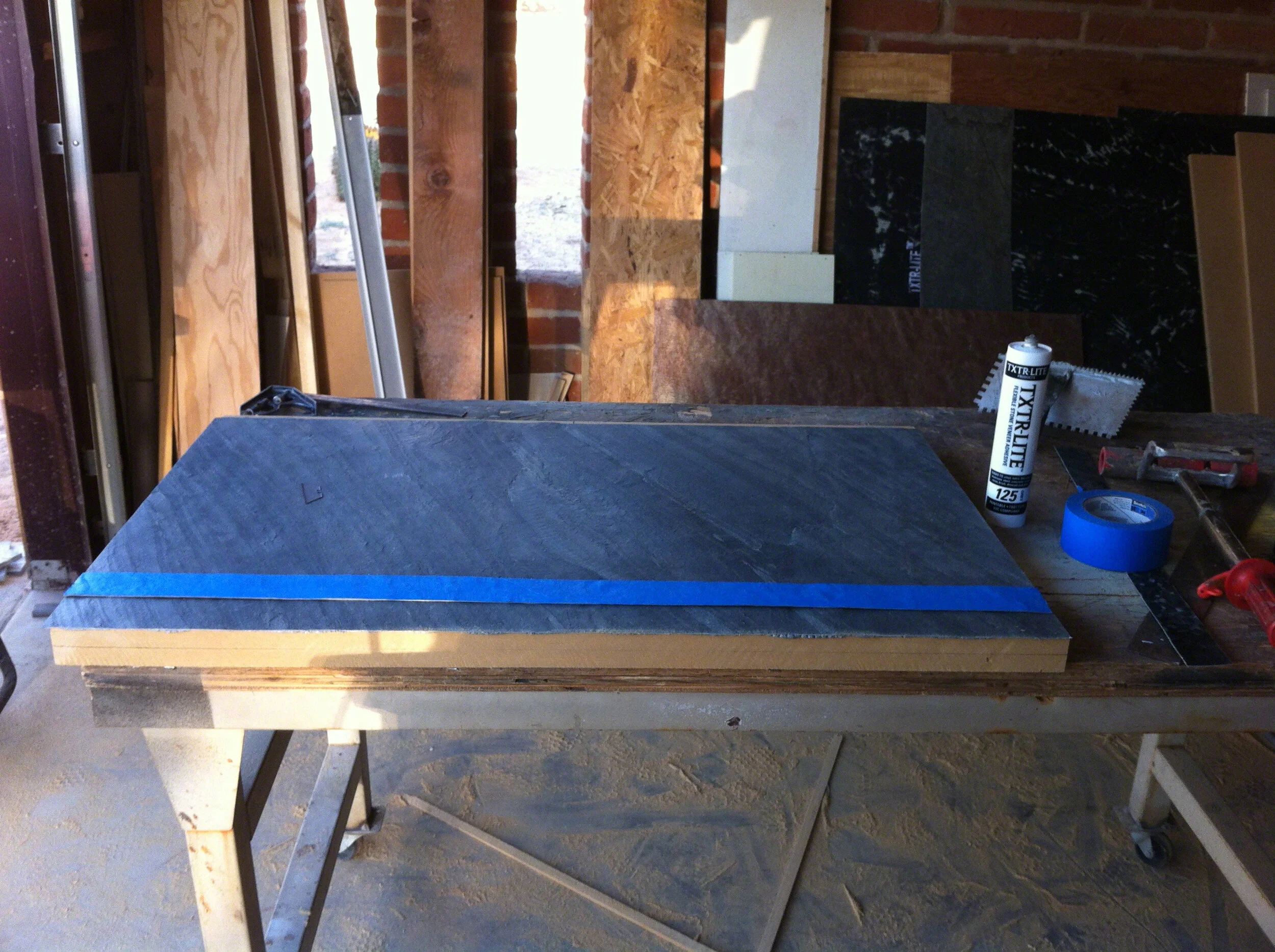 txtr-lite-flexible-stone-veneer-bathroom-vanity-wwtaping edges to protect from glue.jpg
