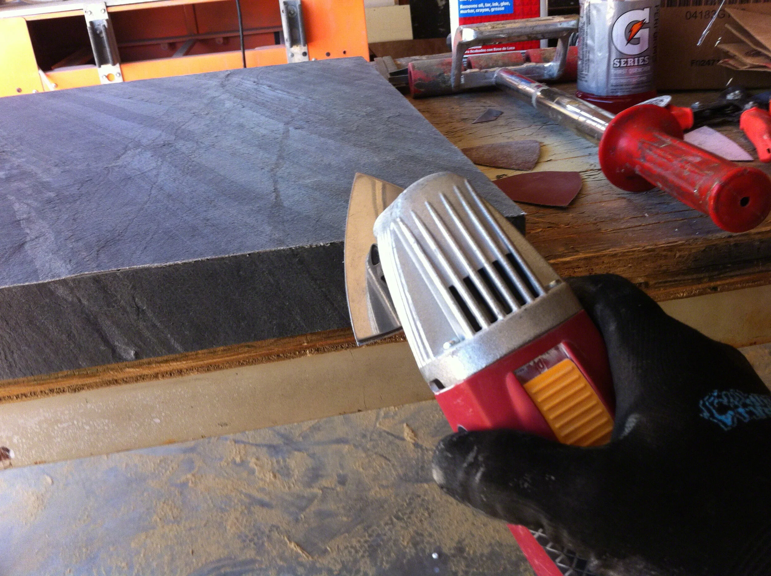 txtr-lite-flexible-stone-veneer-bathroom-vanity-wwusing electric sander to sand edges flush.jpg