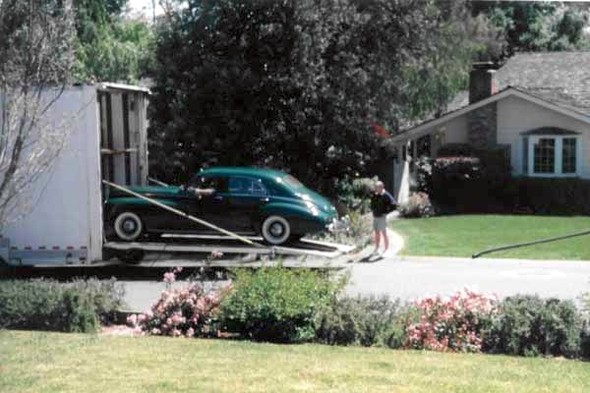 He was without an old car for a number of years, but that changed in 2005, when he acquired a 1941 Packard Clipper sedan. The history of our Packard is interesting. Its original owner was the rich widow of the owner of a coal mine in West Virginia. When she died, the car went to her niece, who drove it for a few years. There were a few short-term owners and it then ended up in a museum in West Virginia. The museum sold it to a private owner, who drove it home to Phoenix, Arizona. When he died, his wife sold it to Roy. Here is a picture of the exciting day when it arrived and was unloaded at our front door in February 2005.