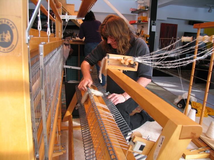 Charly loading one of our looms for a new series of throws in our Haliburton studio.