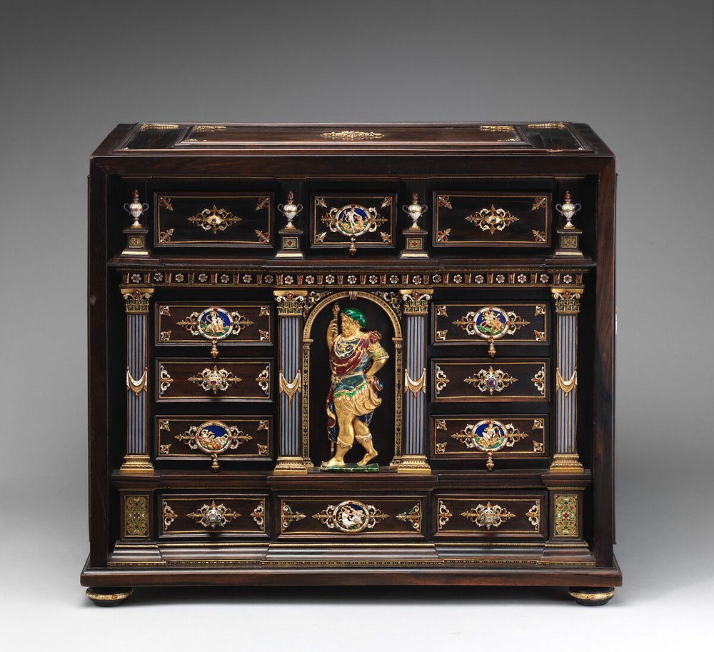 Cabinet with gold mounts and relief