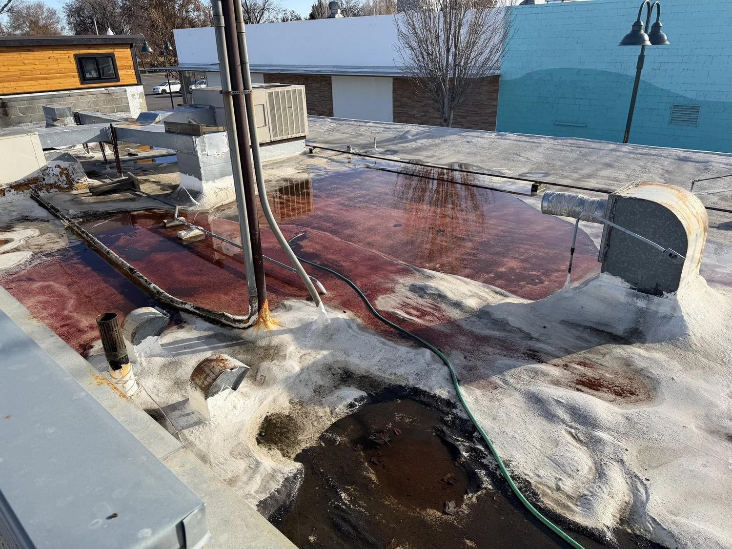 Failed commercial roof membrane with ponding water and blistering before replacement, Richland, Washington