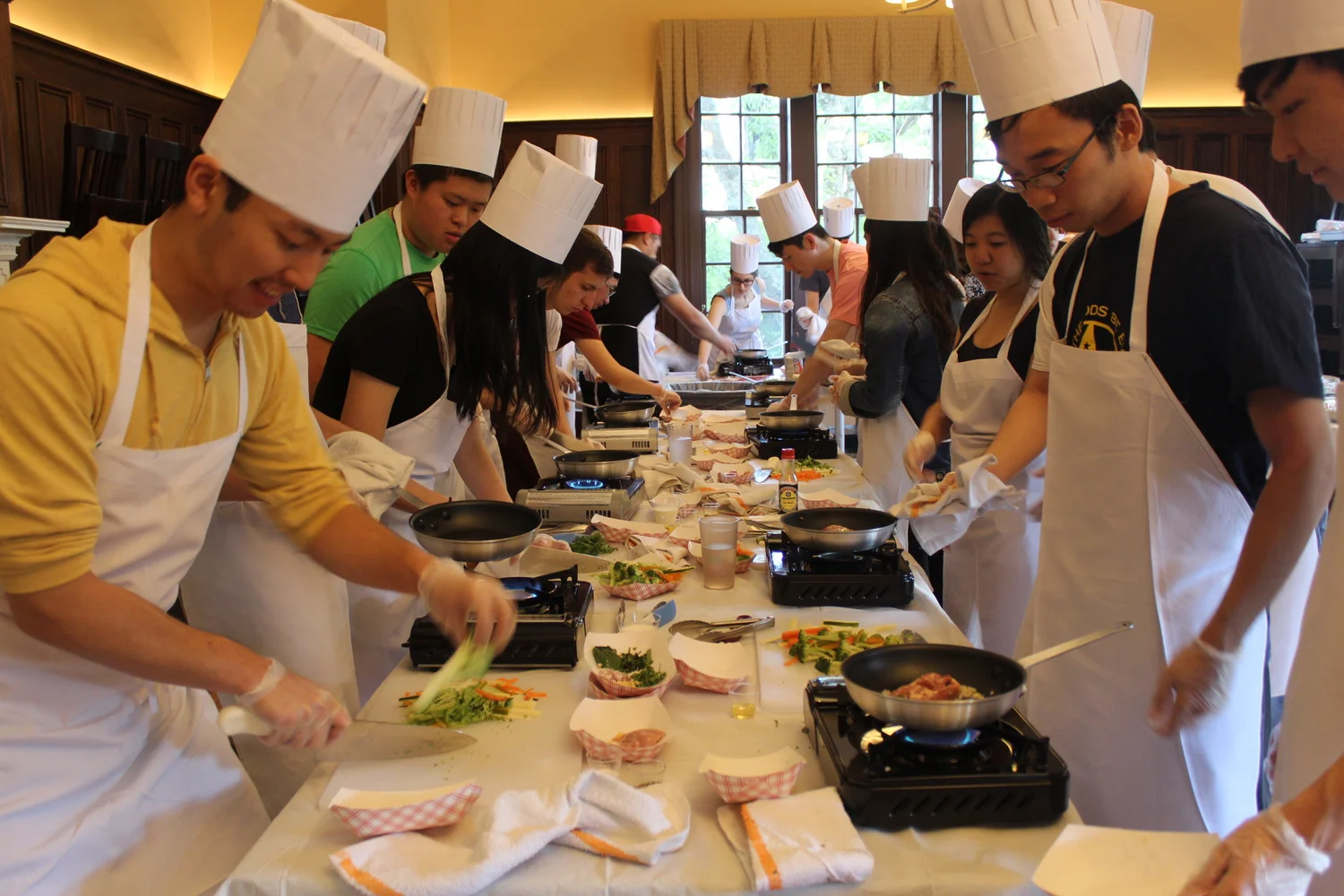 Members preparing food together at the club’s cooking class in 2019