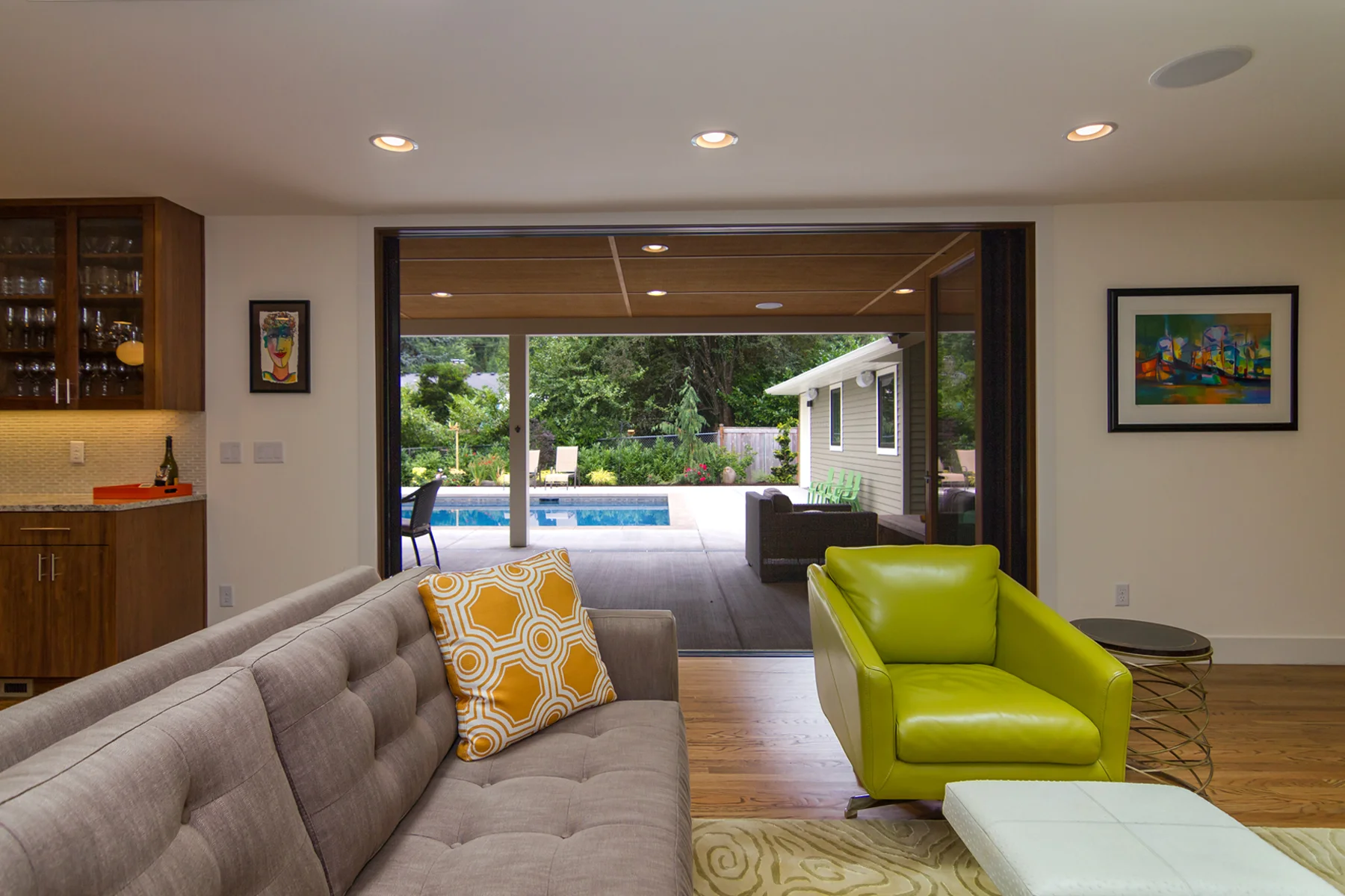 New La Cantina doors open fully to open to create a seamless transition from the living room to the outdoor living space and pool.
