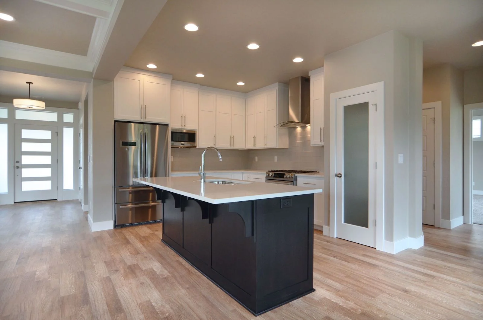 View of the front doorway, Chef's Kitchen and hallway to the master bedroom suite.