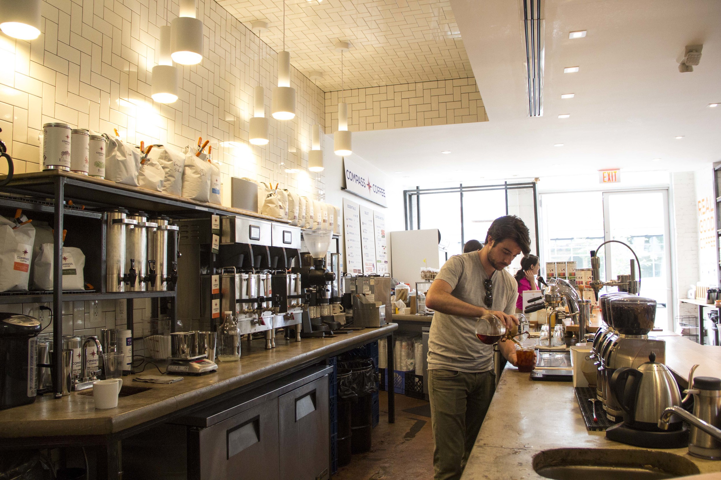 One of Compass Coffee's two founders, kindly making this reporter an iced pour over behind the counter at their 7th Street location. Photo courtesy Robins. 