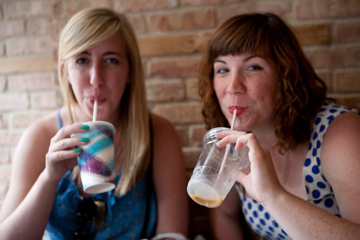 Katie and Theresa drinking iced coffee in Brooklyn after junior year of college