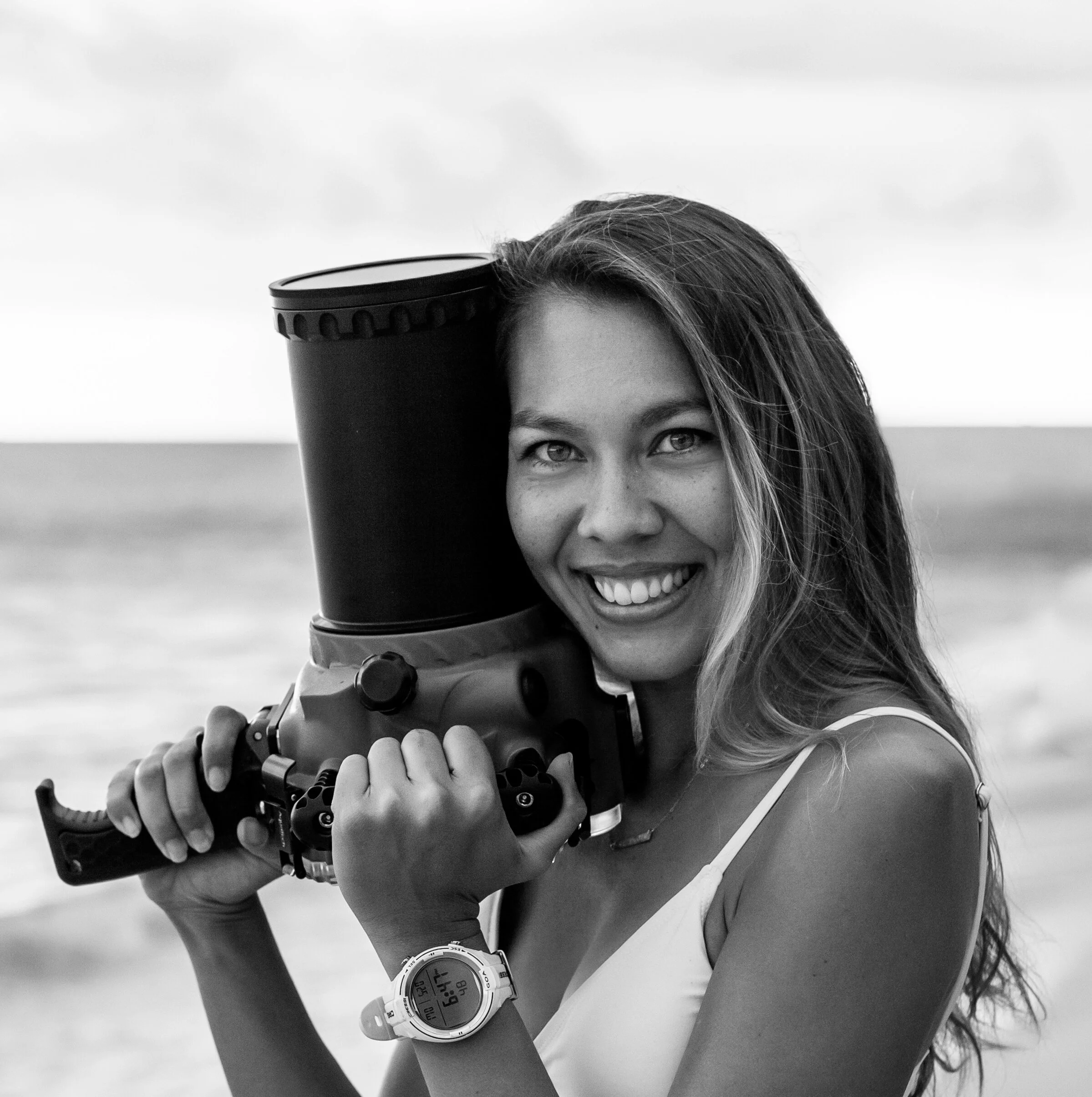 AsiaBrynne, Oahu Surf Photographer, holding an Aquatech Waterhousing and wearing a Cressi dive computer