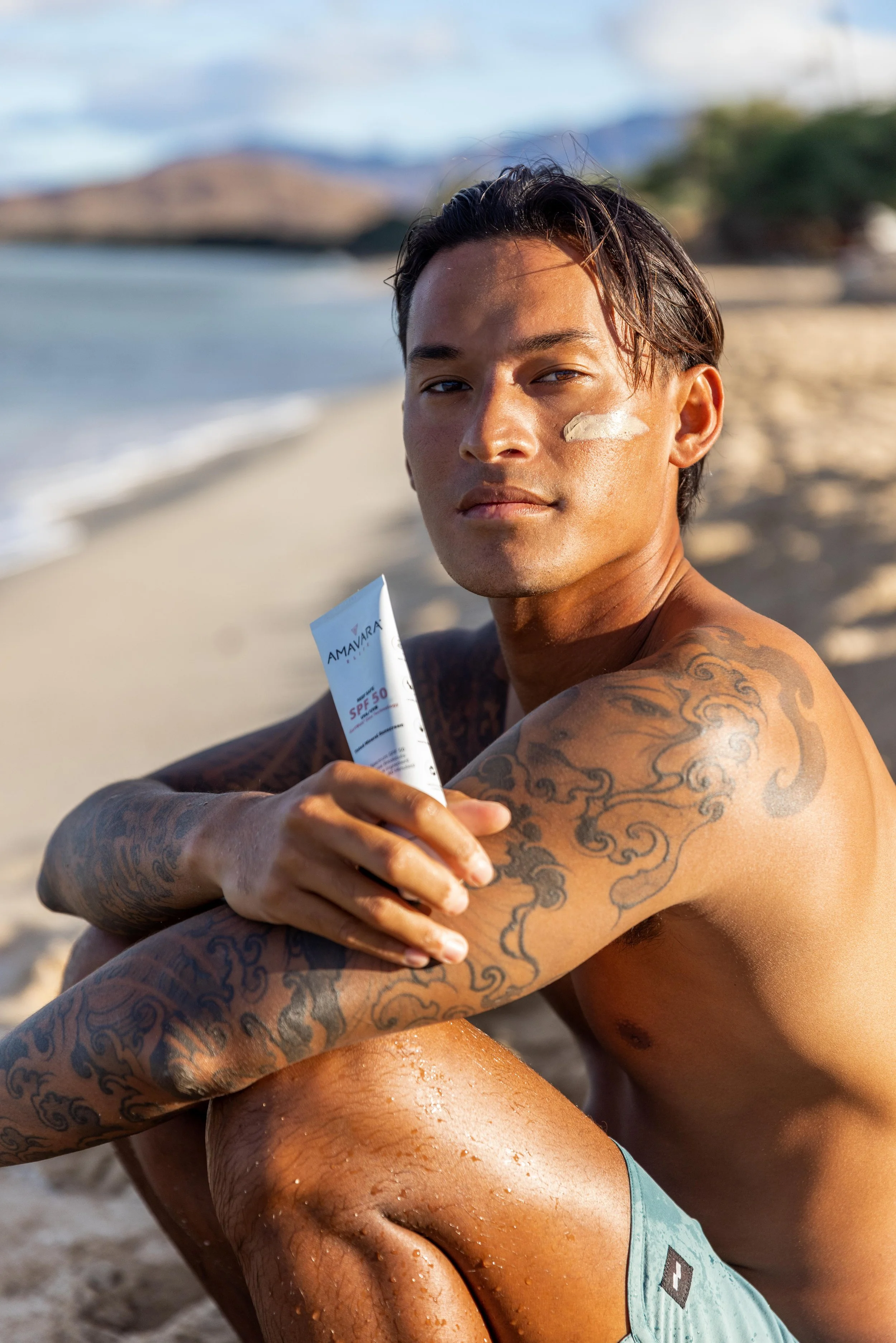 Blaze Rivera holding Amavara Sunscreen in Hawaii
