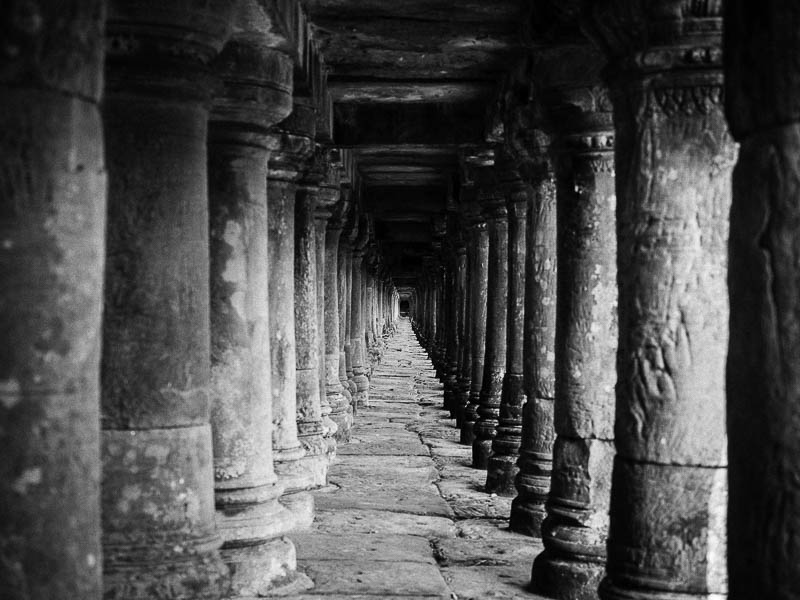 Underneath an elevated walkway leading to another temple
