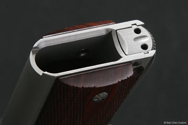 Magwell bevel with common mainspring housing