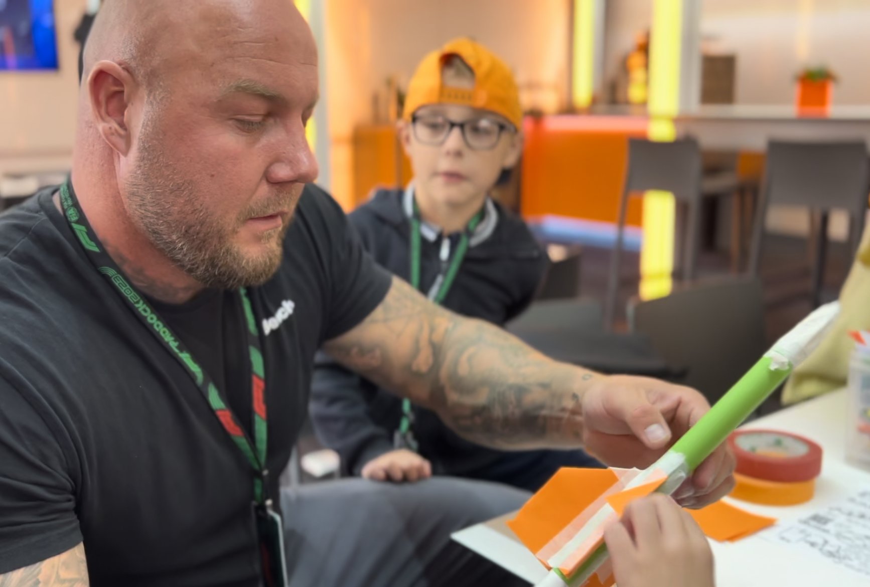 Shropshire Dad Dan Perks makes a paper rocket with his twin sons Ollie and Charlie in the McLaren pits at Silverstone.JPEG