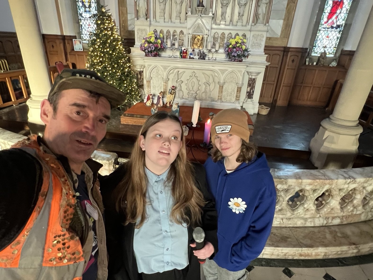 Emily, Jackson and Nick Corston in front of altar of chapel at St Vincent's School