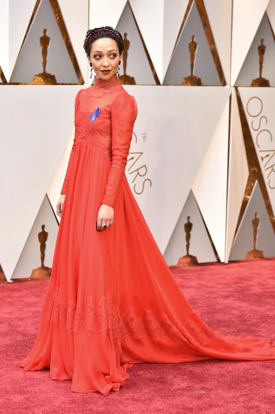 Ruth Negga stuns in this Valentino Haute Couture dress, Bally shoes, jewels by Gemfields and Irene Neuwirth. But her best accessory? The ACLU blue support ribbon. 