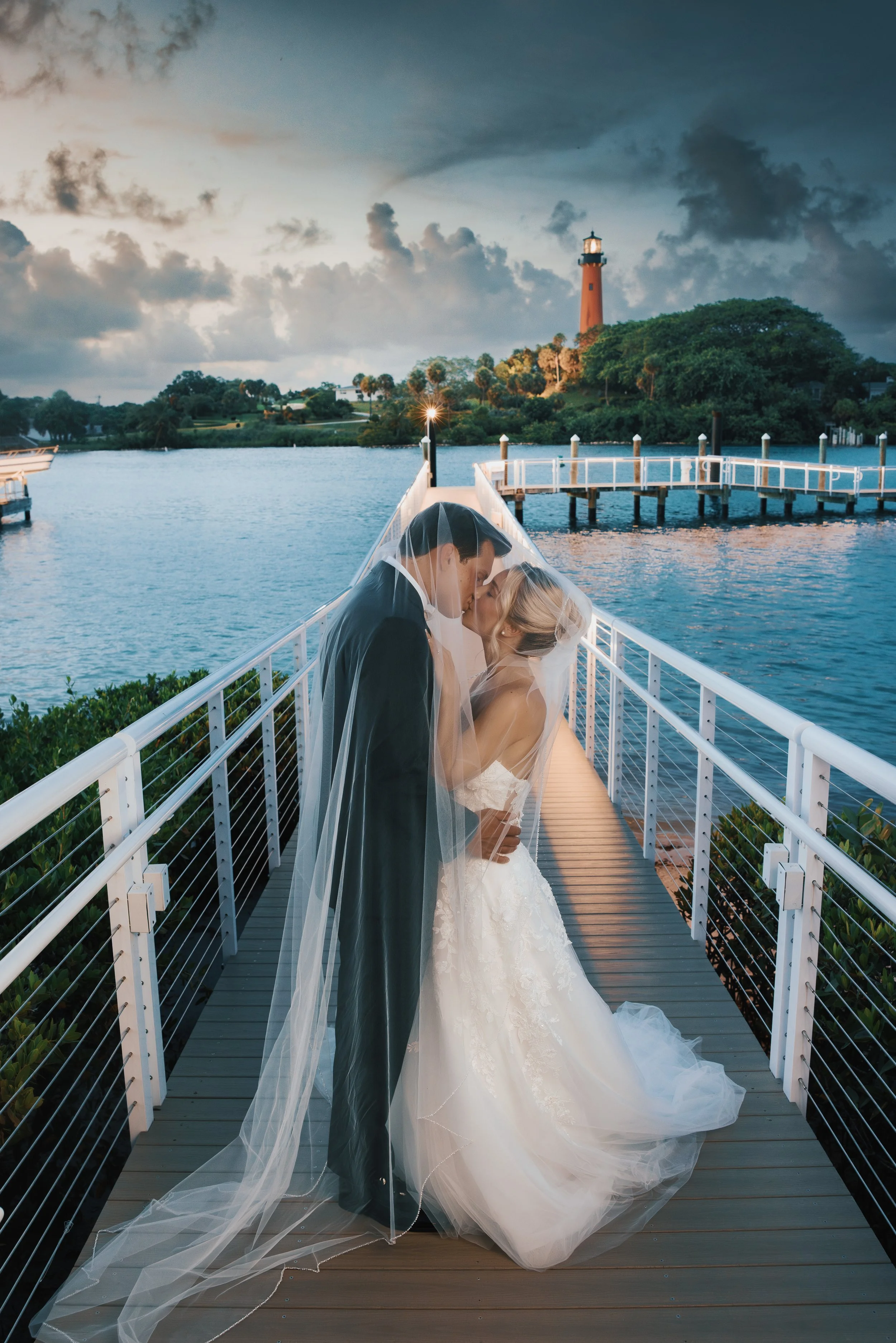 Couple kissing at Jupiter Inlet Lighthouse at sunset