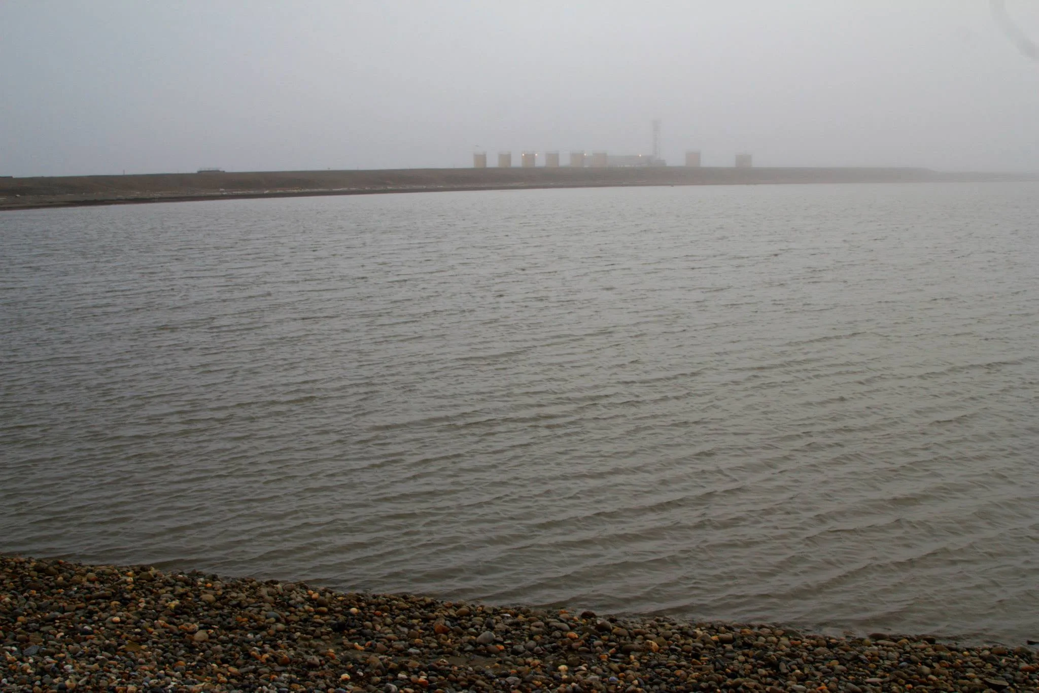 Oil facilities in the background.