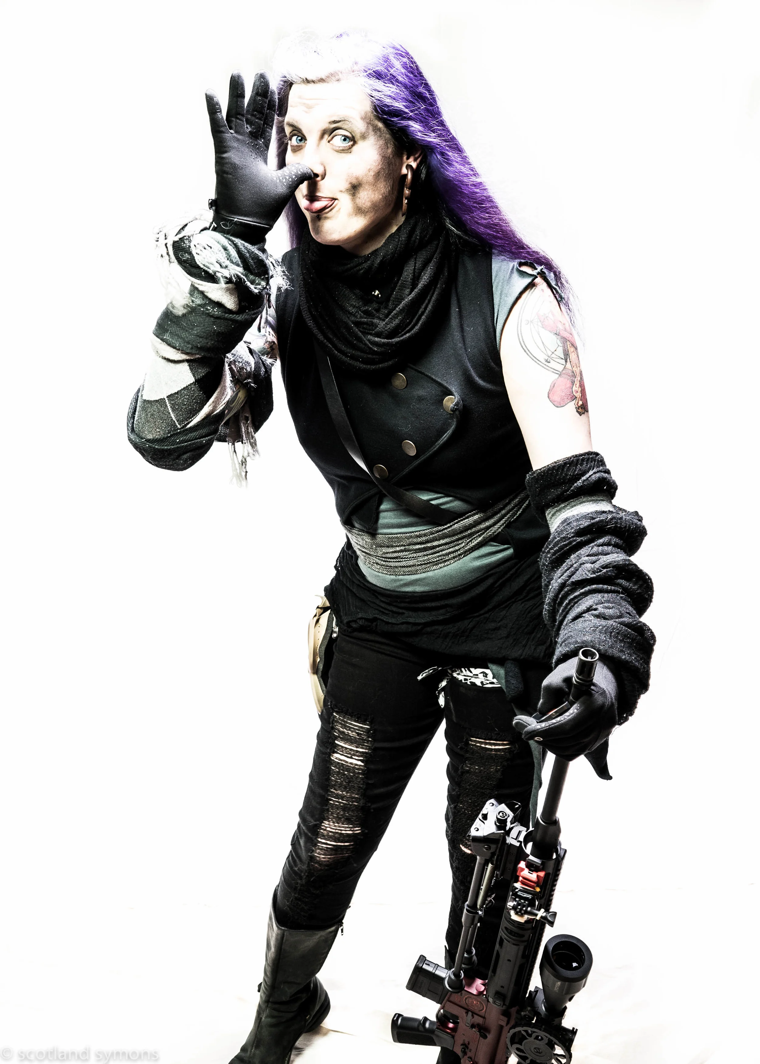 Story By Tristan Crouch "The Vuvulini Sniper has killed more wasteland scavs than anyone, being responsible for closing the trap on those their "bait" brings in. However, removed via scope from the visceral horror of close combat, they have also seen numerous sisters die at adistance. The sniper's relationship with their weapon keeps them sane - the world lost the soma of television in the collapse, and with it, the luxurious sense of detachment from the horrors of the world it provided. Despite their cold and steady killing hand, the sniper has been uniquely able to keep a sense of humor that many of their sisters have pushed into dormant places out of hard necessity, as the tragedies of the world will always be something that happens to somone else, far away. Their sisters do not begrudge them the luxury - not only has the sniper turned the tide of many a battle by felling dozens as if by act of goddess; but the warmth they bring to the table at the end of the day through their cracked perspective and genuine laughter makes the harsh reality of survival more bearable, day after day - no matter the number of newly empty seats at the table."