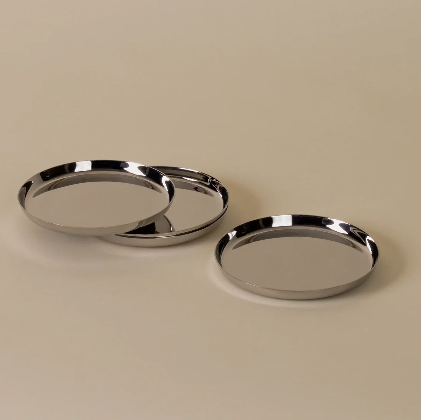 Holcomb_Puddle_Coasters_Polished_Stainless_Steel_1a.webp