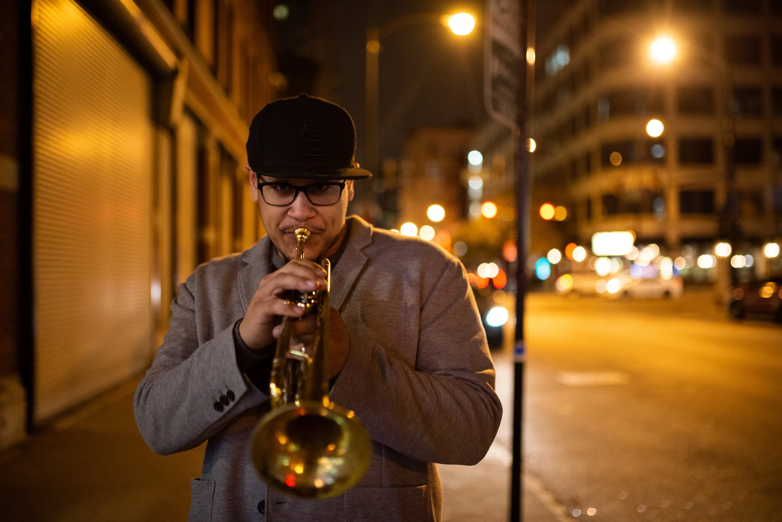 Marques Carroll has carved his own path as a musician and an educator both nationally and internationally. For the diverse trumpeter who has dedicated his time pursuing music with determination and curiosity, Marques has turned his passion into a career and a life long journey. Marques’s palette for music spans from the rich texture of the Blues, Jazz, Classical, World Music, R&B, Soul, Funk, Afrobeat and Hip Hop. These many styles not only influence his playing and writing but his educational field as well. Marques grew up in St. Louis, MO continuing the trumpet tradition made possible by such trumpeters as Clark Terry, Miles Davis, Russell Gunn, Jeremy Davenport and the likes of the young lions Keyon Harold, Quentin Coaxum and Danny Campbell. Clark Terry made a huge impact on Marques at a very young age and through his career until Terry’s transition. Marques received his Bachelor’s and Master’s Degree in the field of Jazz Studies Performance from DePaul University and while there, Marques was able to perform with and learn from great musicians such as Dick Oates, Tom Harrell, Slide Hampton, Bob Brookmeyer, Jon Fedchock, Nicholas Payton, Joe Lovano, Byron Stripling, Kenny Werner, Clark Terry, Louie Bellson, Jon Faddis, Carl Allen, Jeff Hamilton, Jimmy Heath and Randy Brecker. Marques has become a top call freelance musician who has played lead trumpet for The Chicago Yestet, the Chicago Jazz Ensemble and as a soloist/section performer with such artists as blues guitarist Guy King, Aretha Franklin, The Ojays, The Temptations, The Four Tops, The Cliff Wallace Big Band, Jon Faddis, Christian McBride, Meshell Ndegocello, Etienne Charles and the Victor Goines Ensemble. Marques also has had the pleasure of performing throughout Europe, Russia, Vietnam, Canada, Japan, South America and Mexico in various jazz festivals. Marques spent three years playing in the trumpet section (2016-2019) with The Count Basie Orchestra and is now a permanent sub member. Marques is the leader of The Trumpet Summit and the co-leader of the Chicago Soul Jazz Collective, while also leading his own Quartet, Quintet and Trio. As he continues to stay active on the music scene in Chicago, education has also remained a major passion for Marques. Currently, he is the Musical Director for the Chicago Jesuit Academy (13 years). He has written the course outline and curriculum in which students are exposed to jazz history, theory and instrumental pedagogy. This program has become a cornerstone for the school itself and has provided many students the opportunity to continue their love for music on a higher level. Marques continues to do great work within the Chicago Public School System giving clinics, master classes in trumpet and music performance and working as a mentor to young trumpeters associated with Chicago's Jazz Institute. His Master Classes and Clinics extend past the music and reaches into the “Complete” musician/person. “I believe that we as musicians have a huge responsibility to give back to our youth and especially to those who do not have the opportunity to learn music on a higher level. It’s our duty to help others learn to express themselves in a positive manner.”