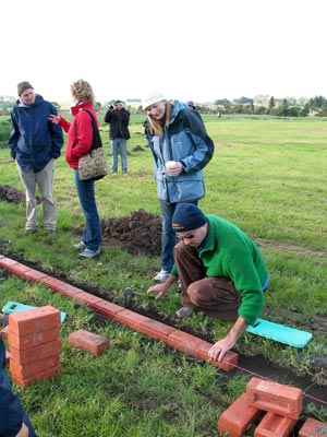 Laying a brick in the diamond lawn edging