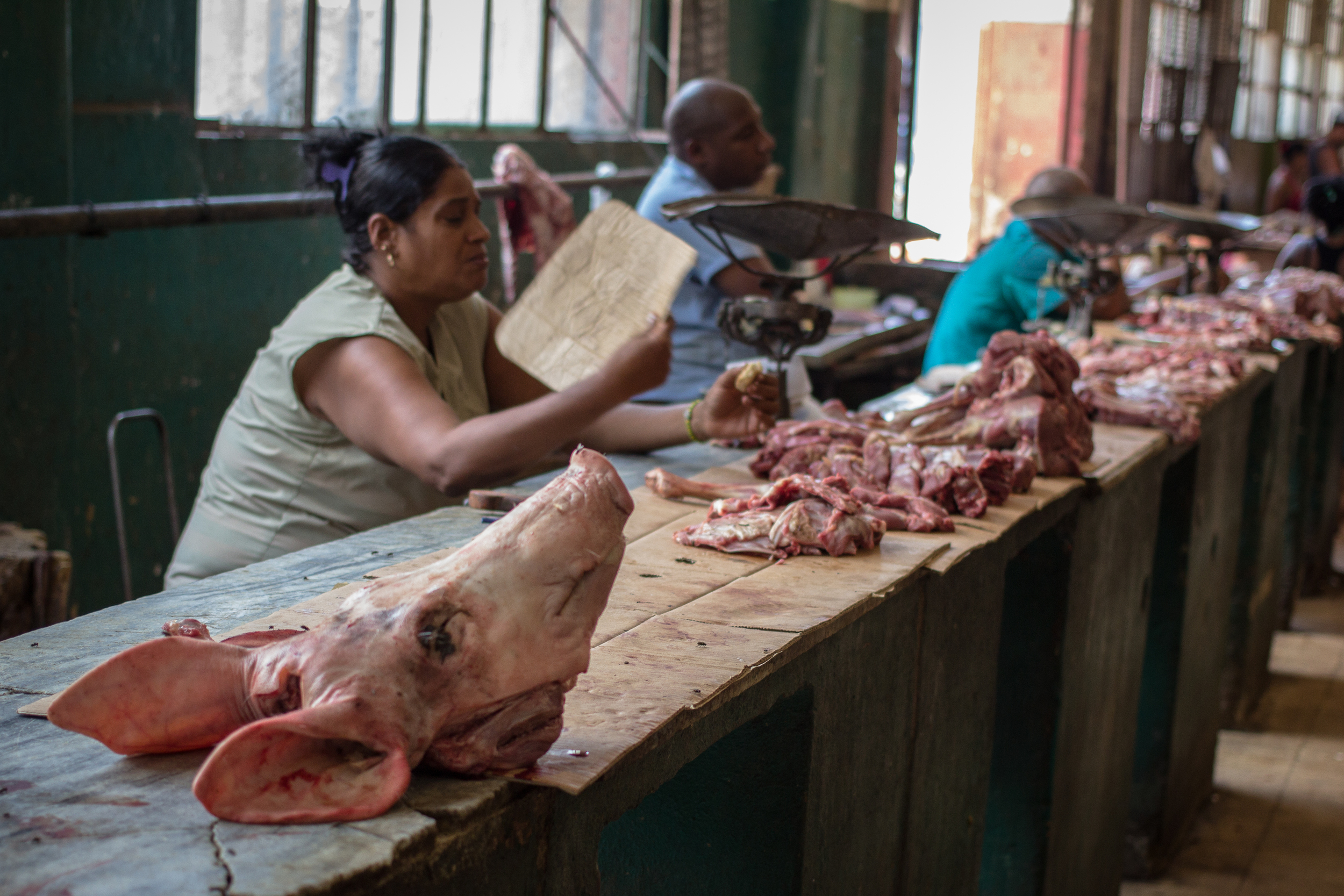 "Puerco" 2013 A market table sorts pig parts at a grocery for Shaman’s rituals.