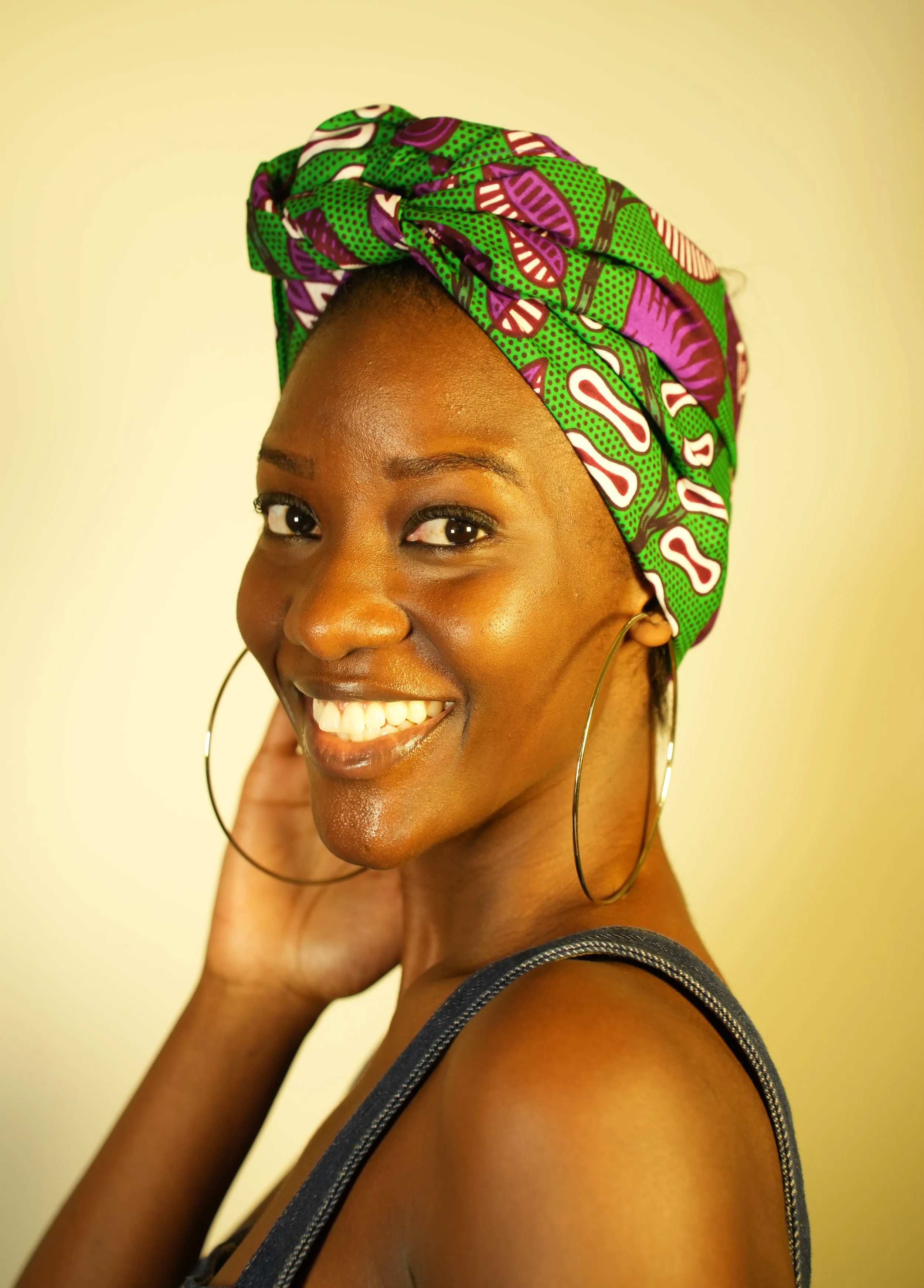 Front view of woman smiling and wearing a headwrap