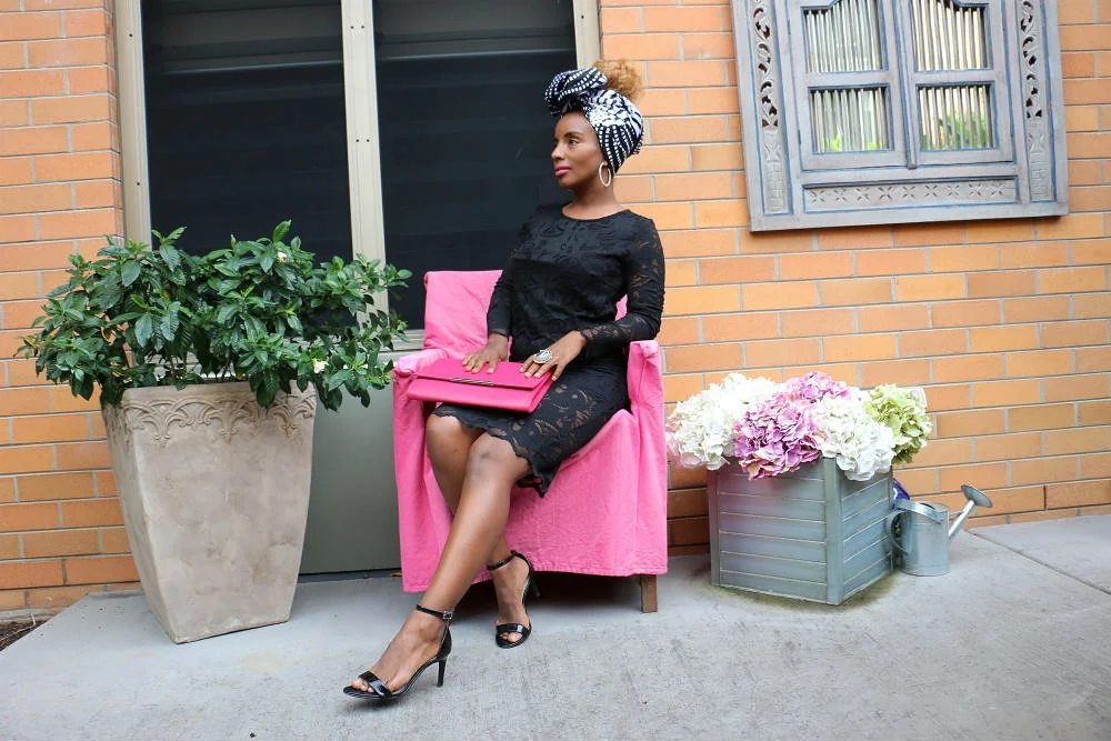 A lush green pot plant, a vintage chair covered in pink and a floral arrangement created a great backdrop for headwrap GUGU . Black heels complete Yeni's wardrobe.